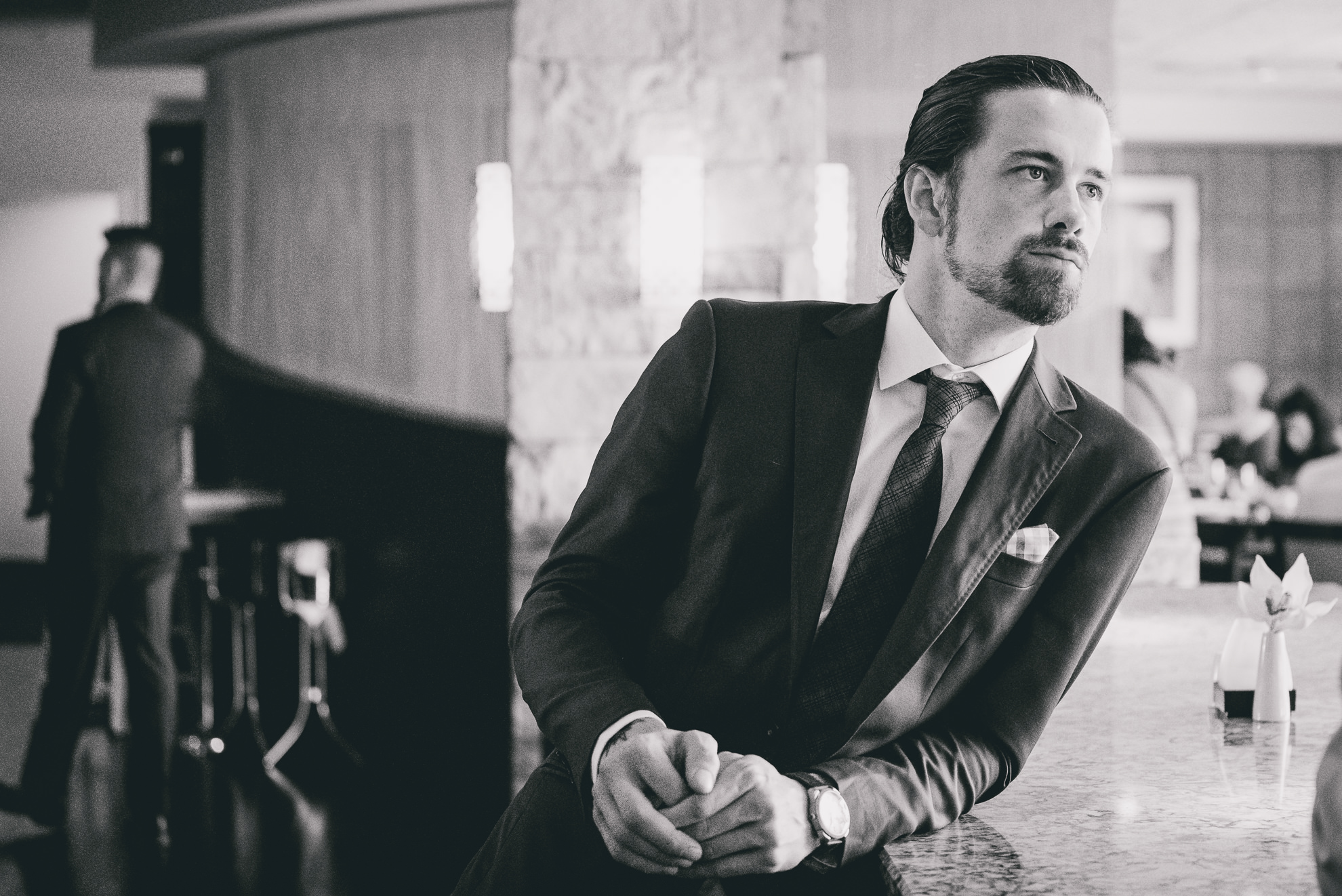 groomsmen poses for photographer at Strathallan Hotel in Rochester, NY before wedding