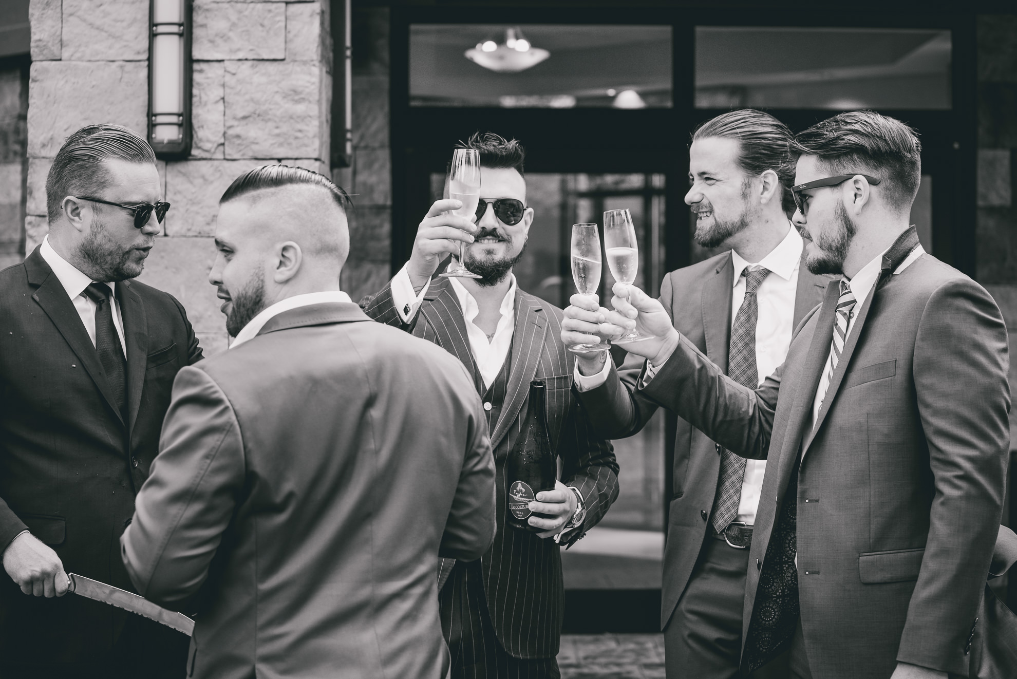 groomsmen toast champagne at Strathallan Hotel in Rochester, NY before wedding