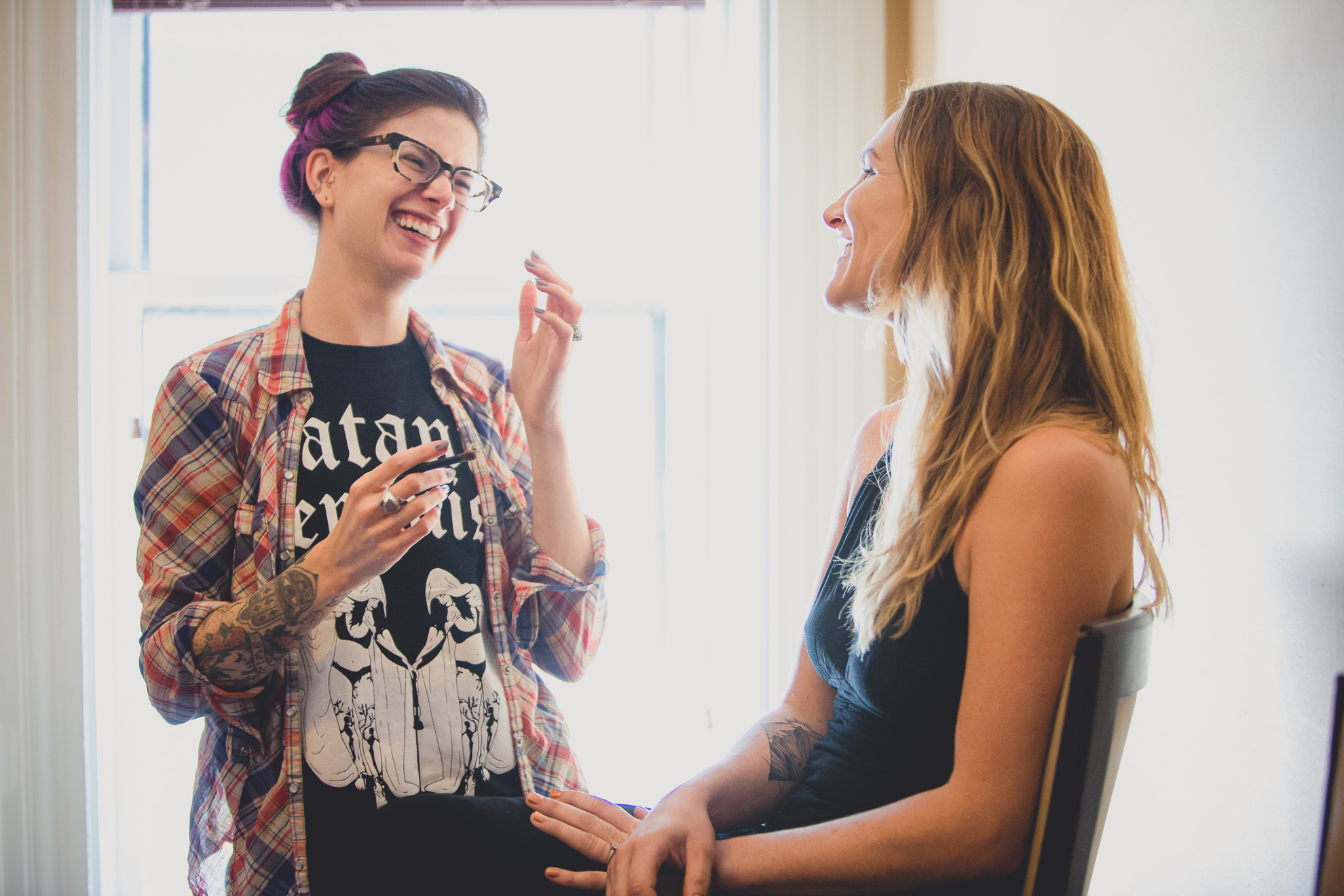 bridesmaids laugh  at Strathallan Hotel in Rochester, NY before wedding