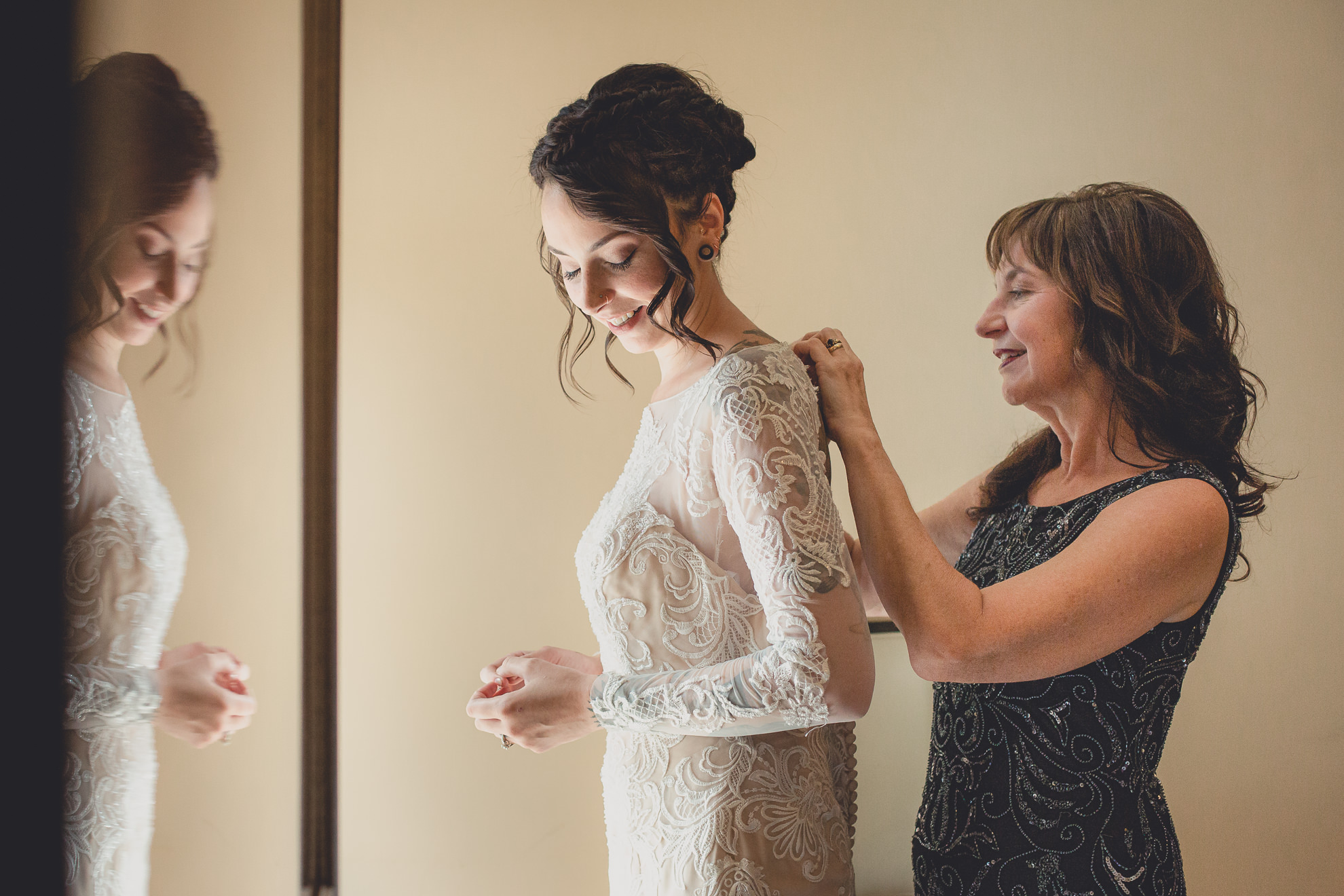 brides mom helps with wedding dress at Strathallan Hotel in Rochester, NY before wedding