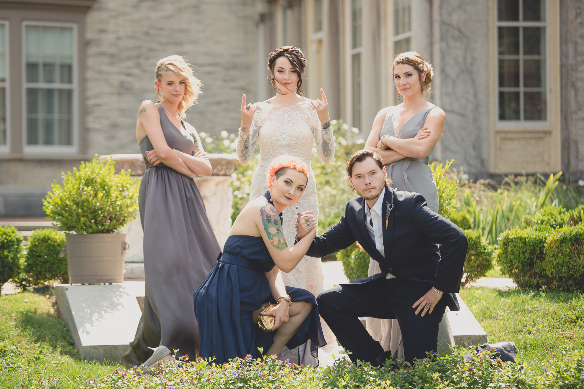 wedding party poses for photographer before garden wedding ceremony at the George Eastman House in Rochester, NY 