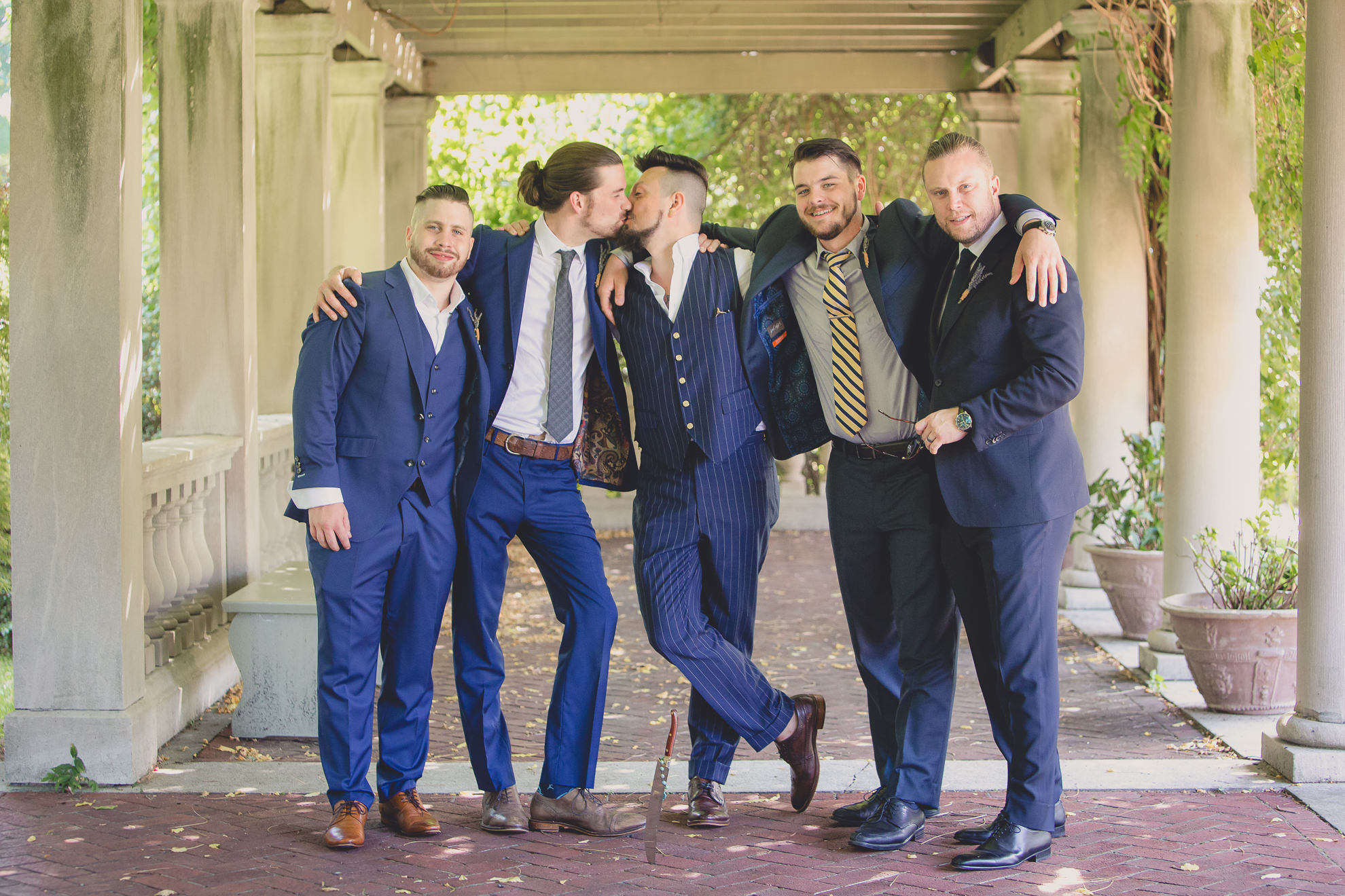 wedding party poses for photographer before garden wedding ceremony at the George Eastman House in Rochester, NY 