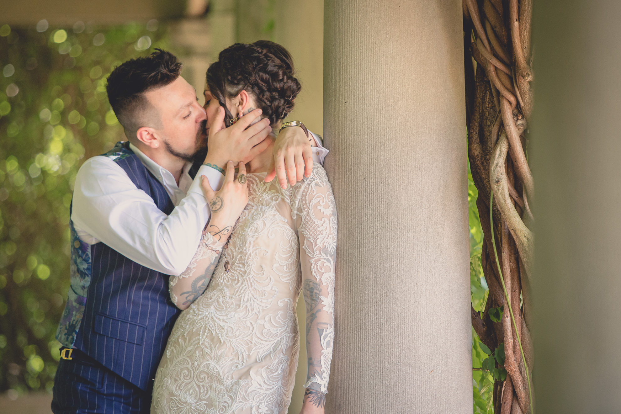 bride and groom pose for photographer before garden wedding ceremony at the George Eastman House in Rochester, NY 