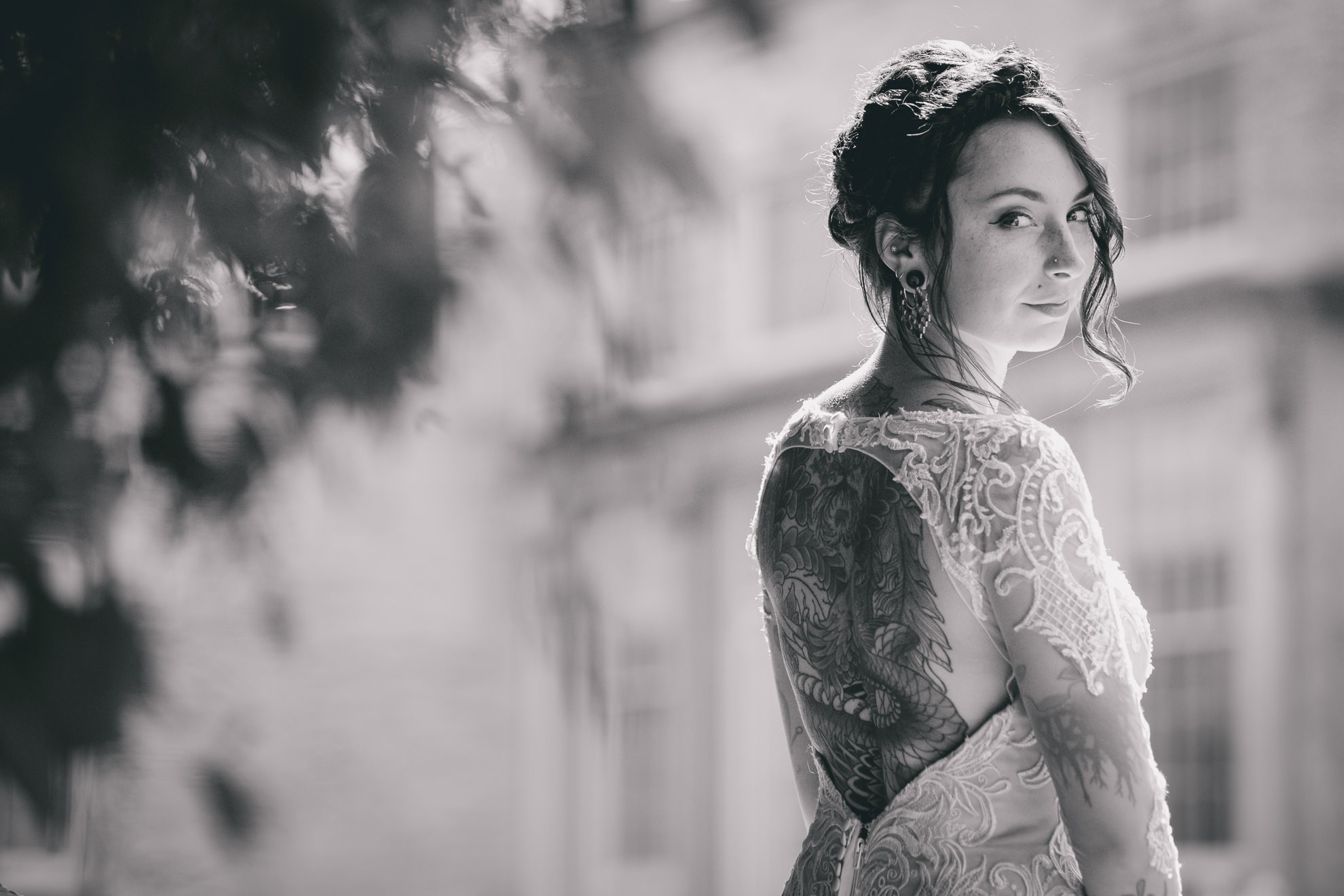 bride poses for photographer before garden wedding ceremony at the George Eastman House in Rochester, NY 