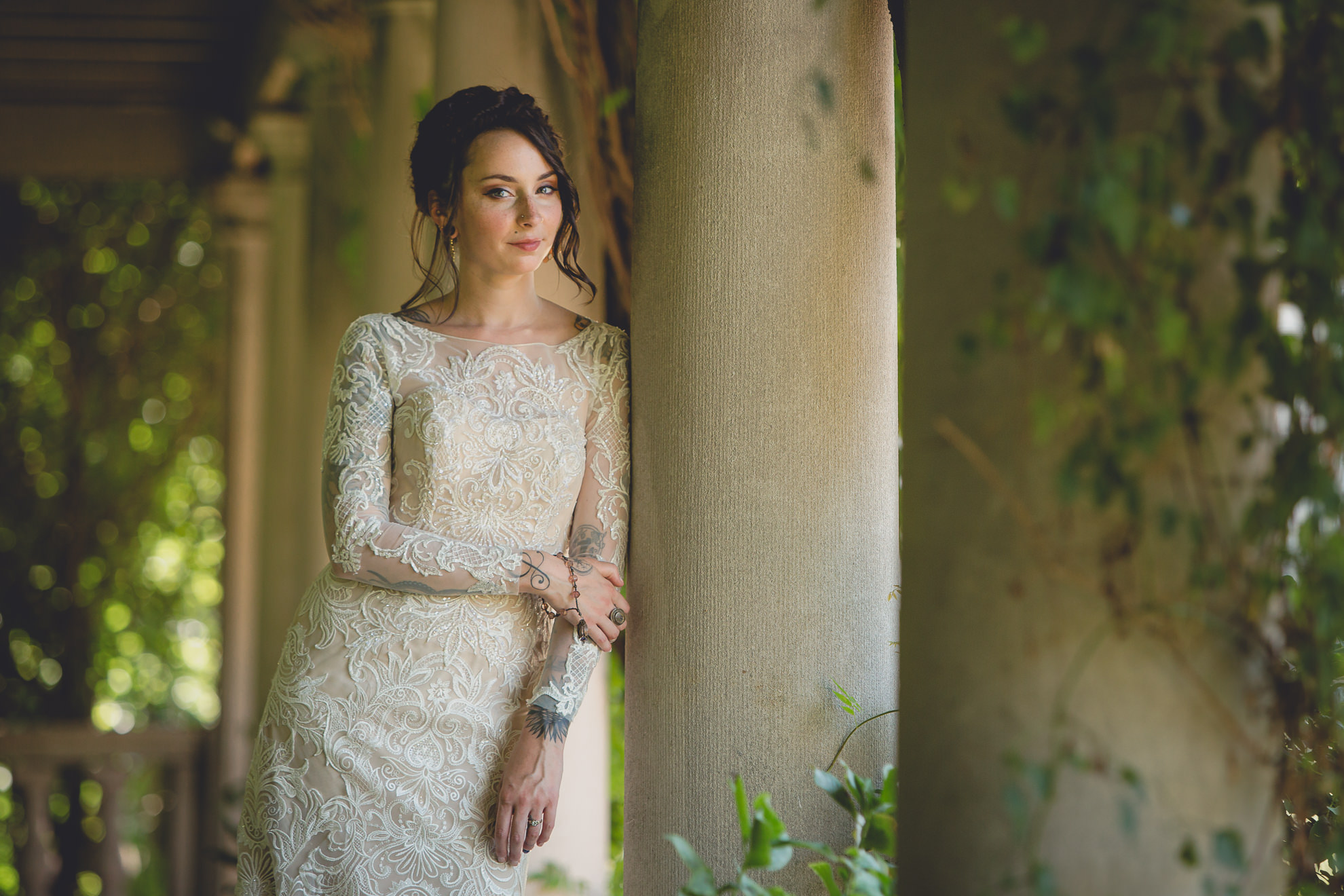 bride poses for photographer before garden wedding ceremony at the George Eastman House in Rochester, NY 