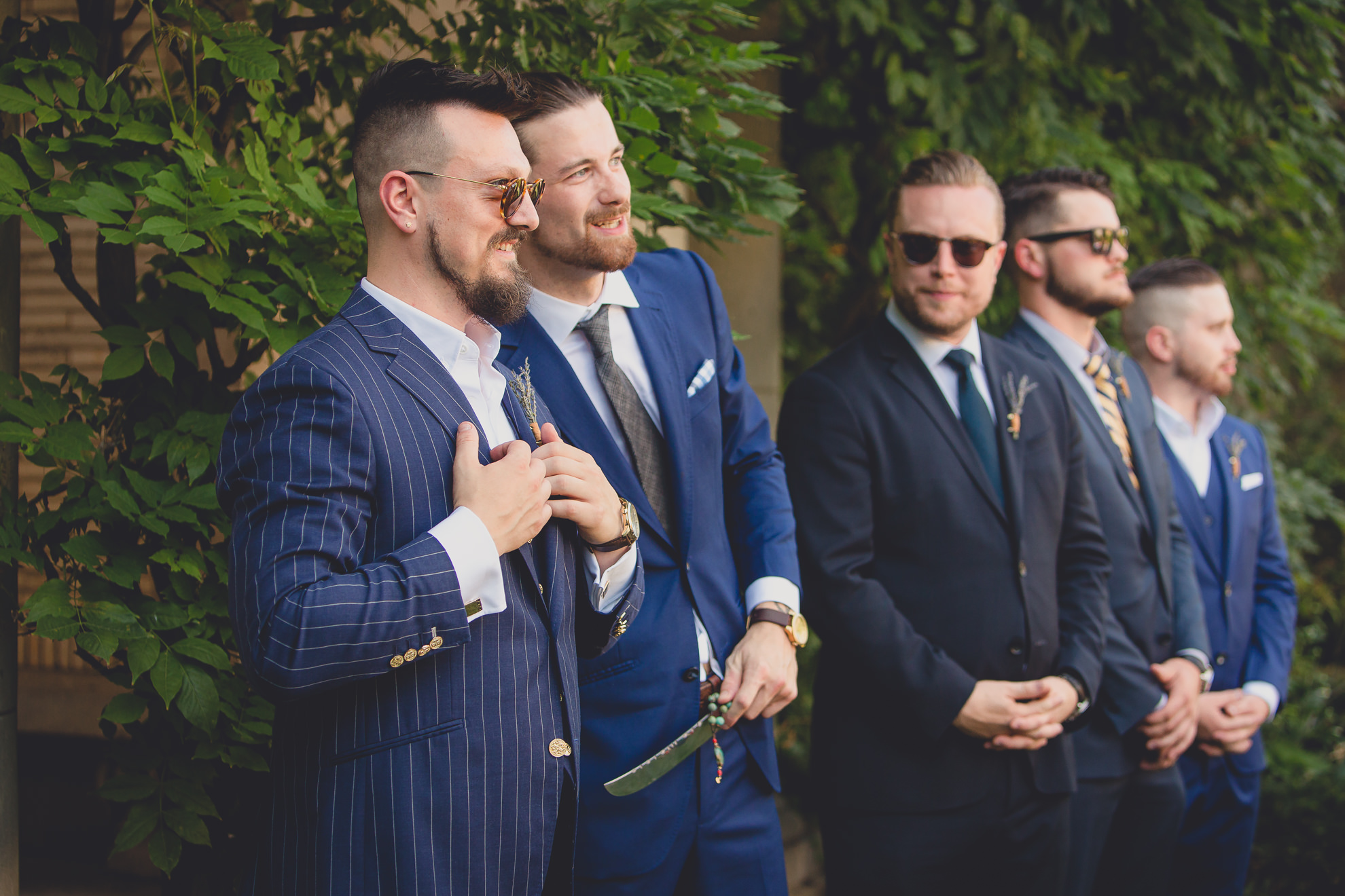 groom watches bride come down aisle during garden wedding ceremony at the George Eastman House in Rochester, NY 
