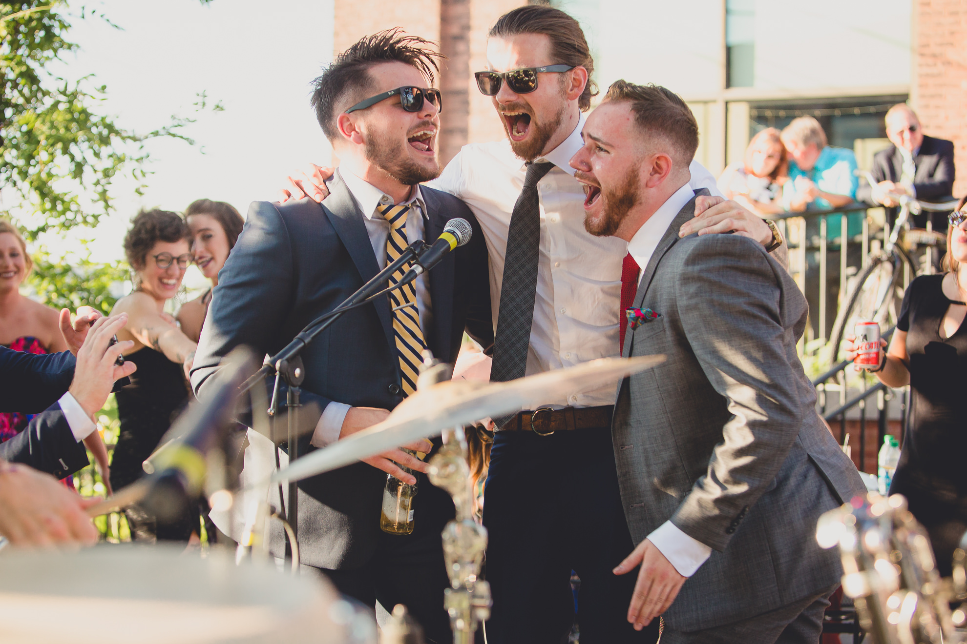guests sing with band emefe during outdoor wedding reception at the Revelry in Rochester, NY 