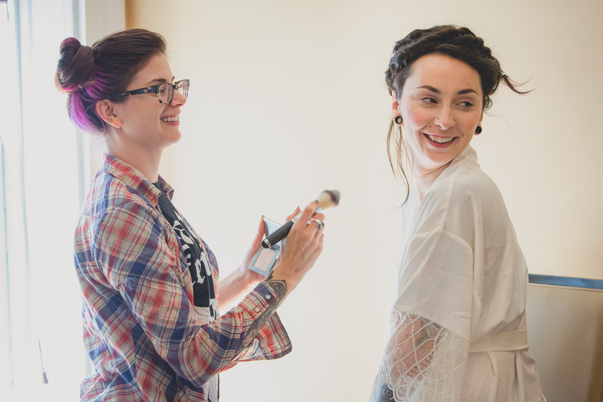 bride gets makeup done at Strathallan Hotel in Rochester, NY before wedding