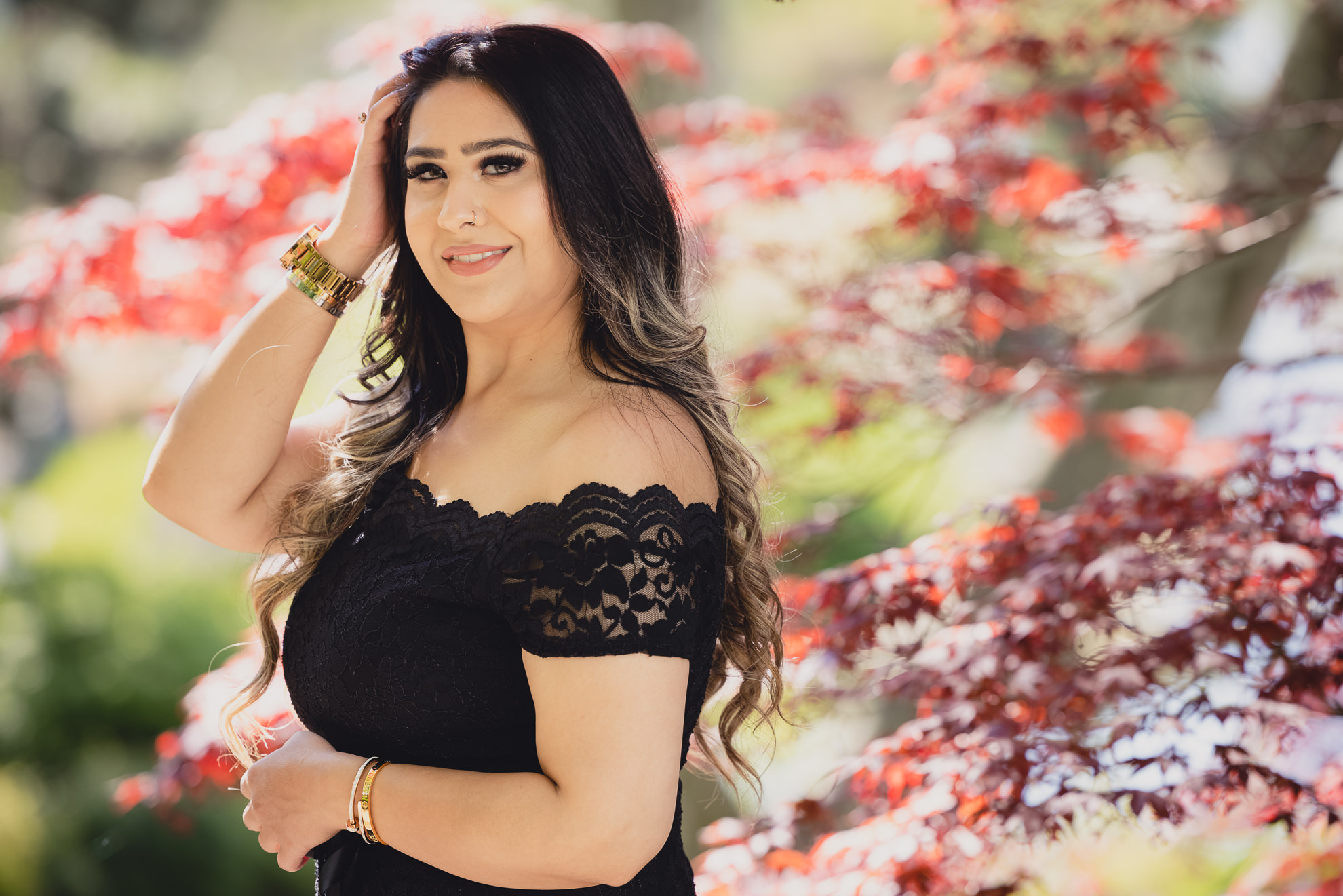graduate smiles for photographer during senior graduation portrait photography at the Japanese Gardens in Buffalo, NY