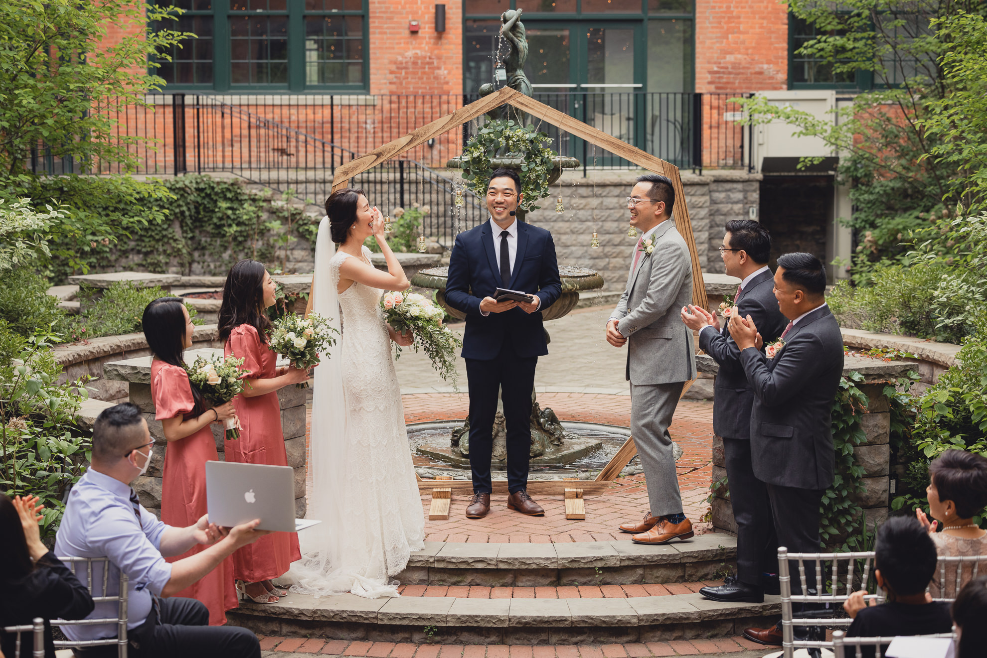 bride and groom laugh during wedding ceremony at the Foundry Suites in Buffalo, NY