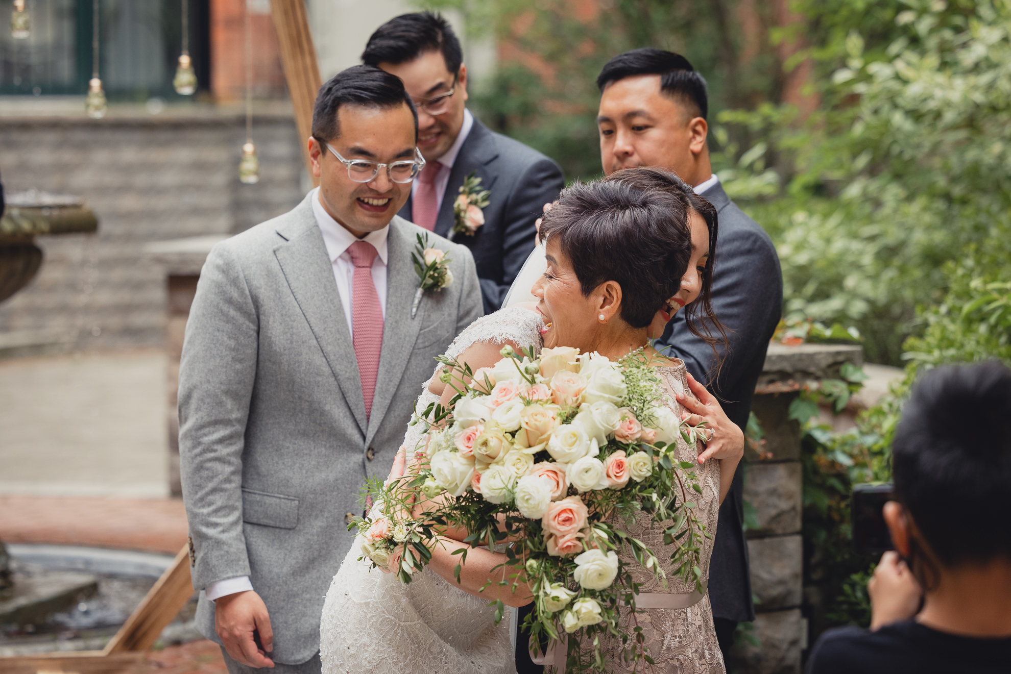 bride hugs mom during wedding ceremony at the Foundry Suites in Buffalo, NY