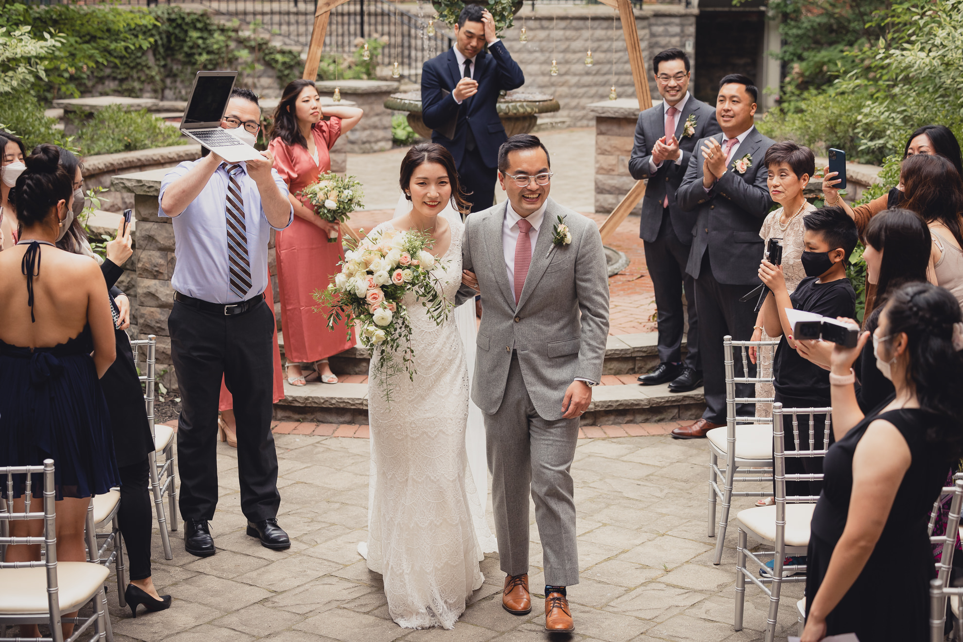 bride and groom walk down aisle during wedding ceremony at the Foundry Suites in Buffalo, NY