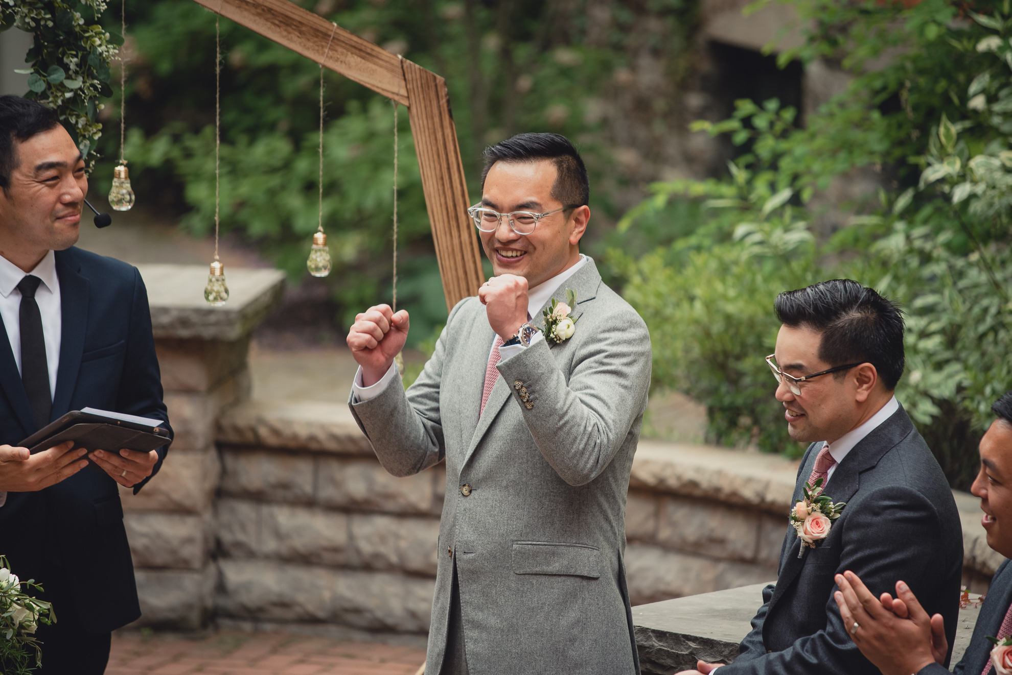 groom cheers during wedding ceremony at the Foundry Suites in Buffalo, NY