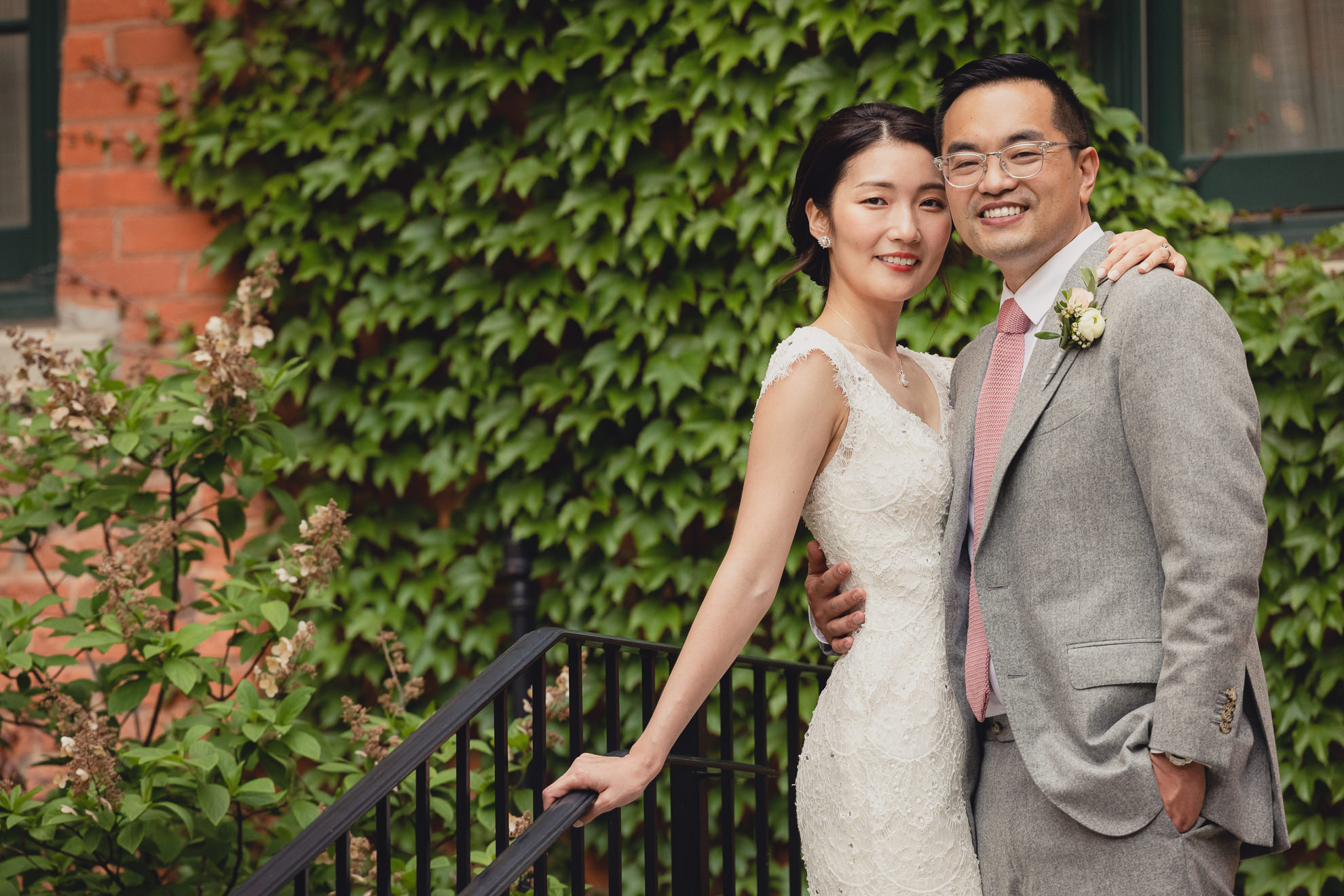 bride and groom pose for photographer during wedding at the Foundry Suites in Buffalo, NY