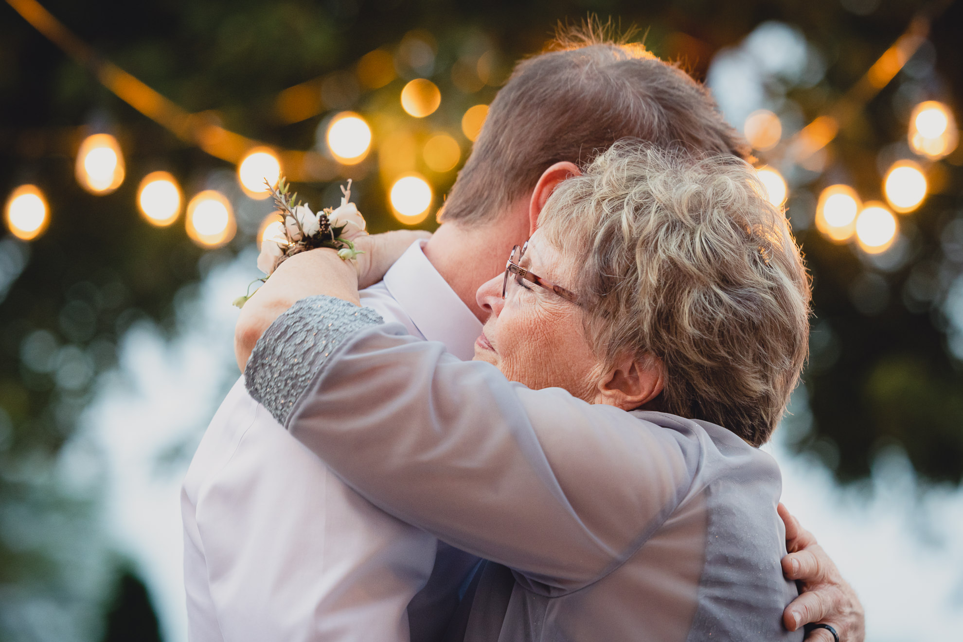 groom and mother dance during their backyard tented wedding in Buffalo, NY