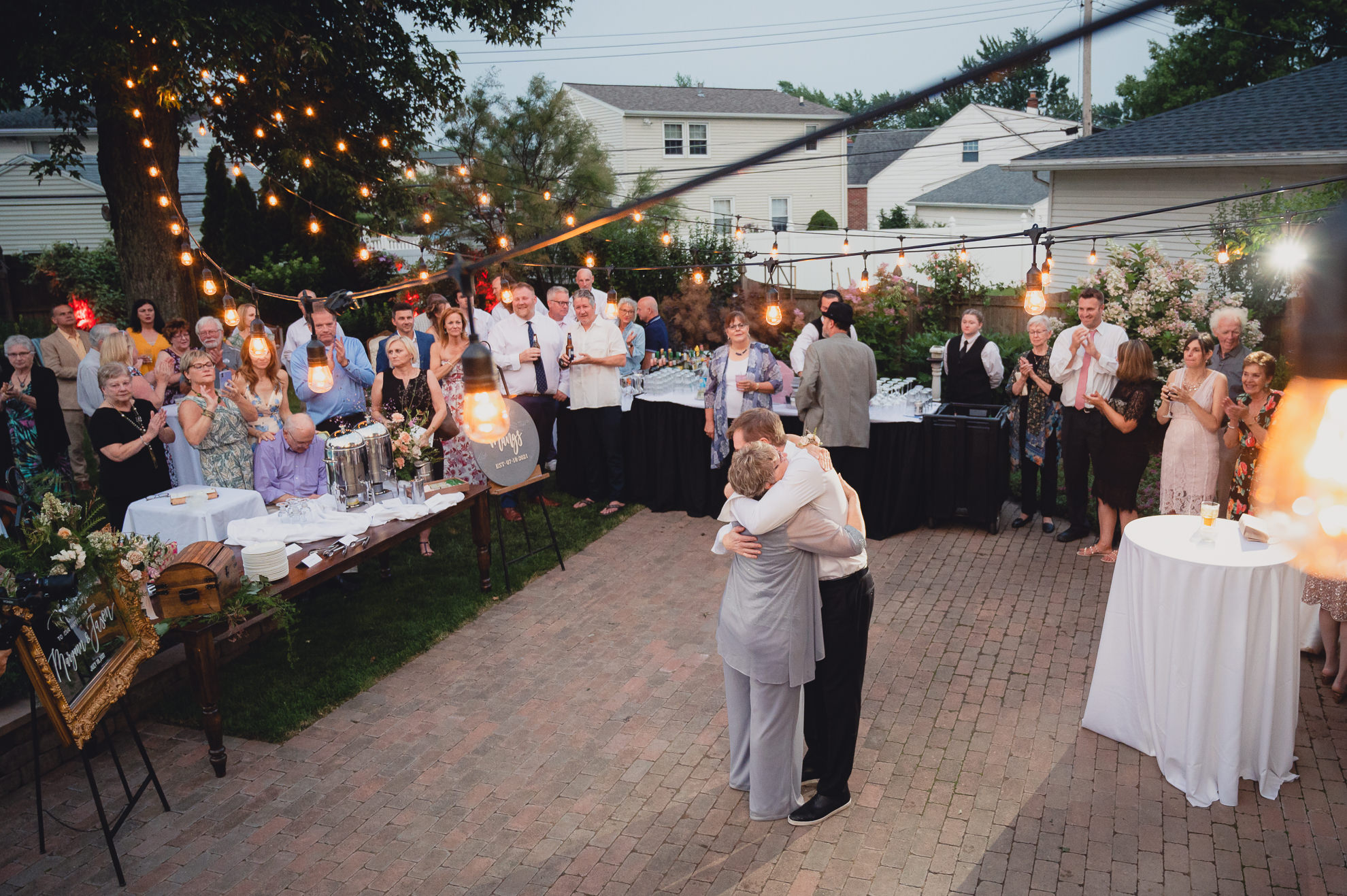 groom and mother dance during their backyard tented wedding in Buffalo, NY