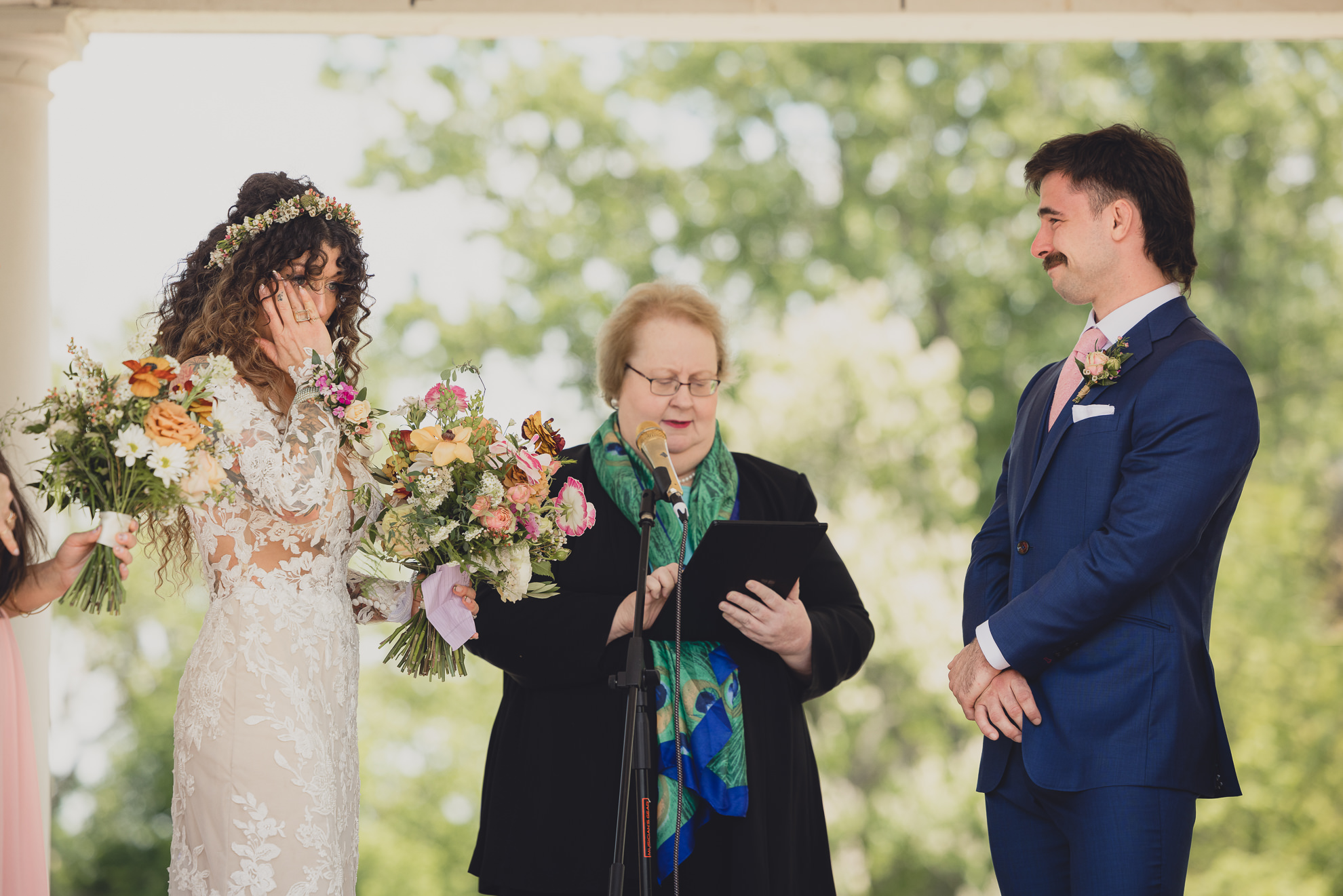 bride wipes tear at the terrace at marcy casino rose garden wedding ceremony