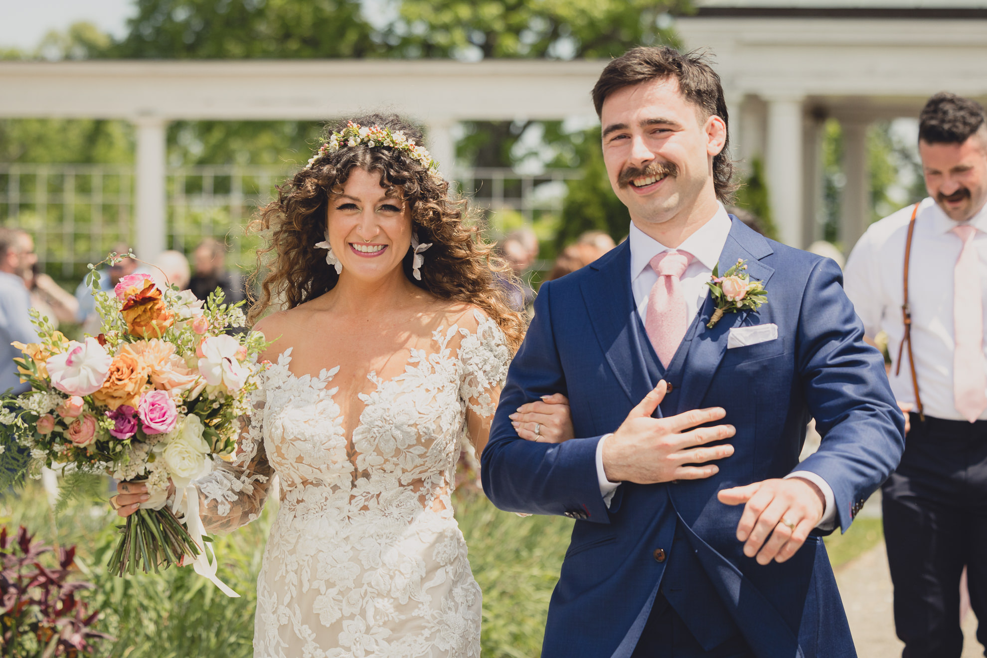 bride and groom walk up aisle