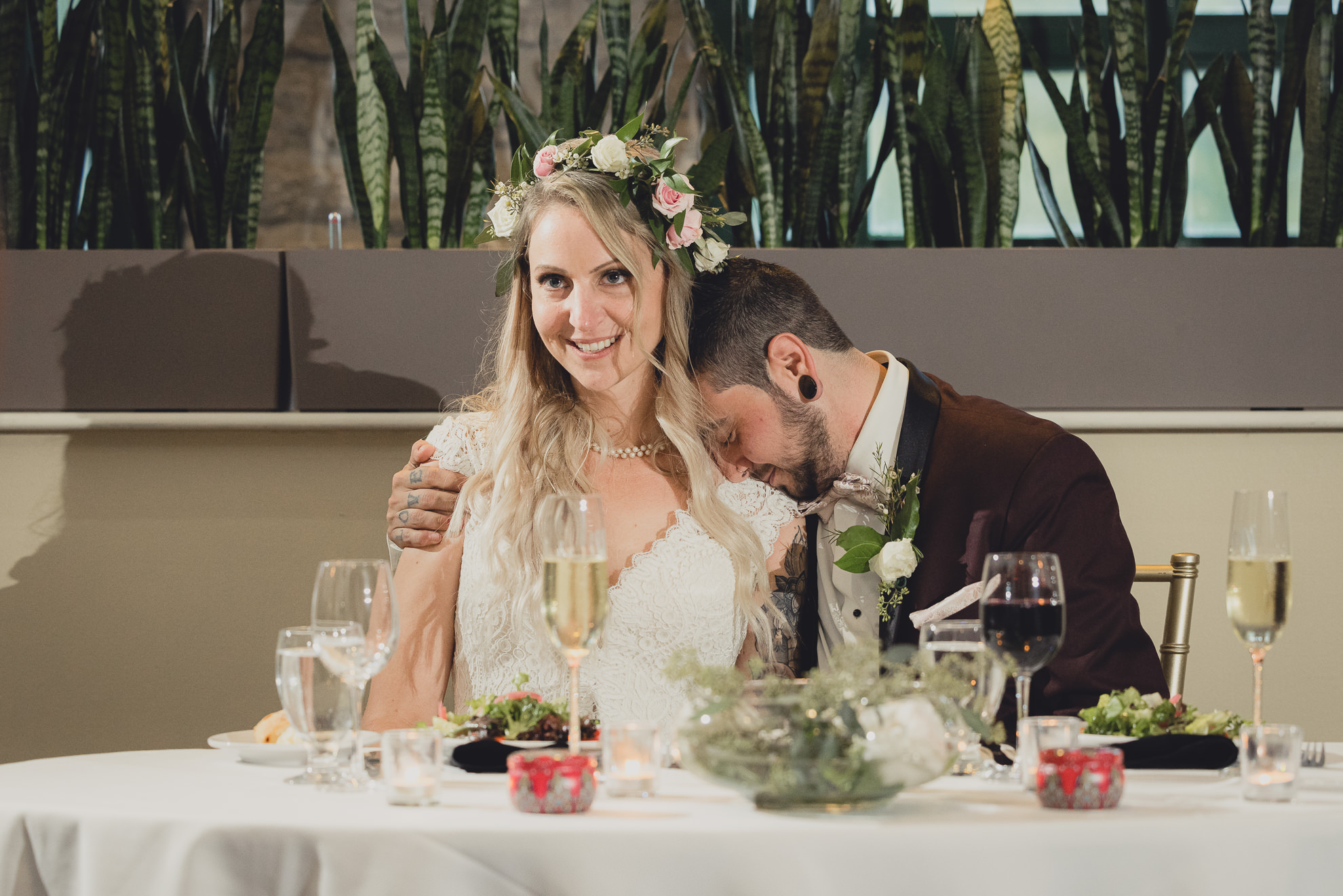 bride and groom cuddle during toasts during wedding at Marcy Casino in Buffalo, NY