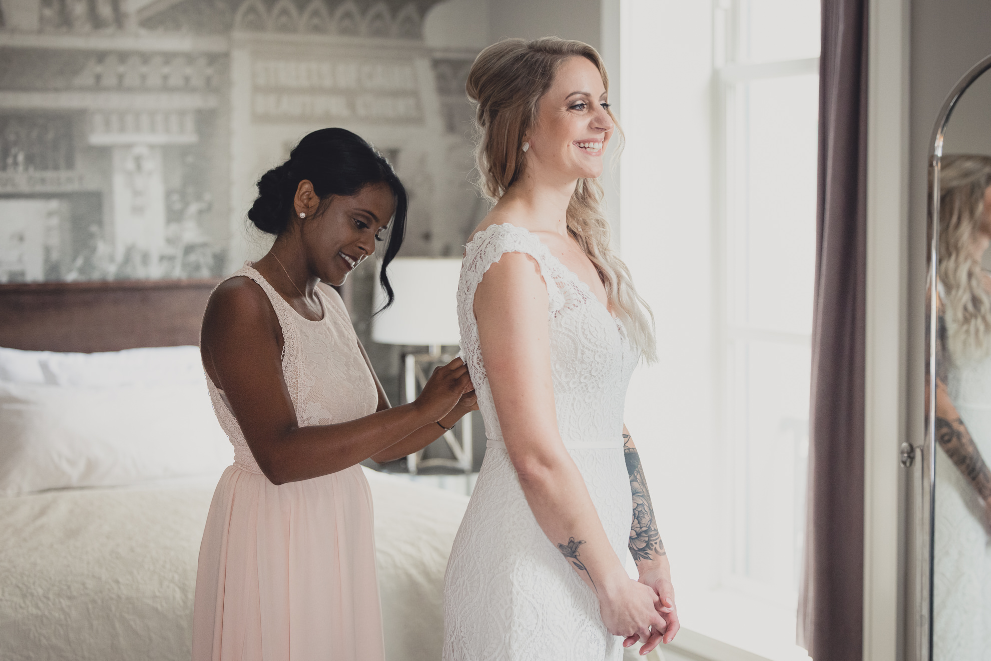 bride smiles while getting ready for wedding at Hotel Lafayette in Buffalo, NY