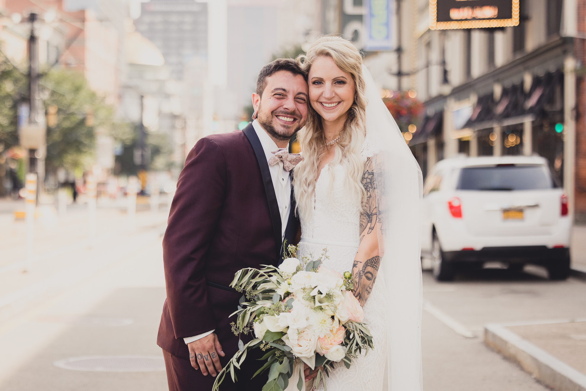 bride and groom pose for wedding portraits near Shea's theater in Buffalo, NY
