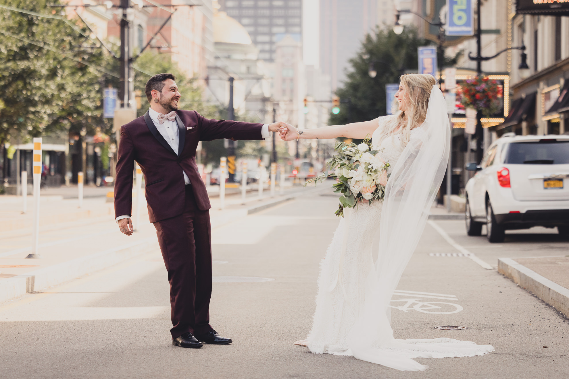 bride and groom pose for wedding portraits near Shea's theater in Buffalo, NY