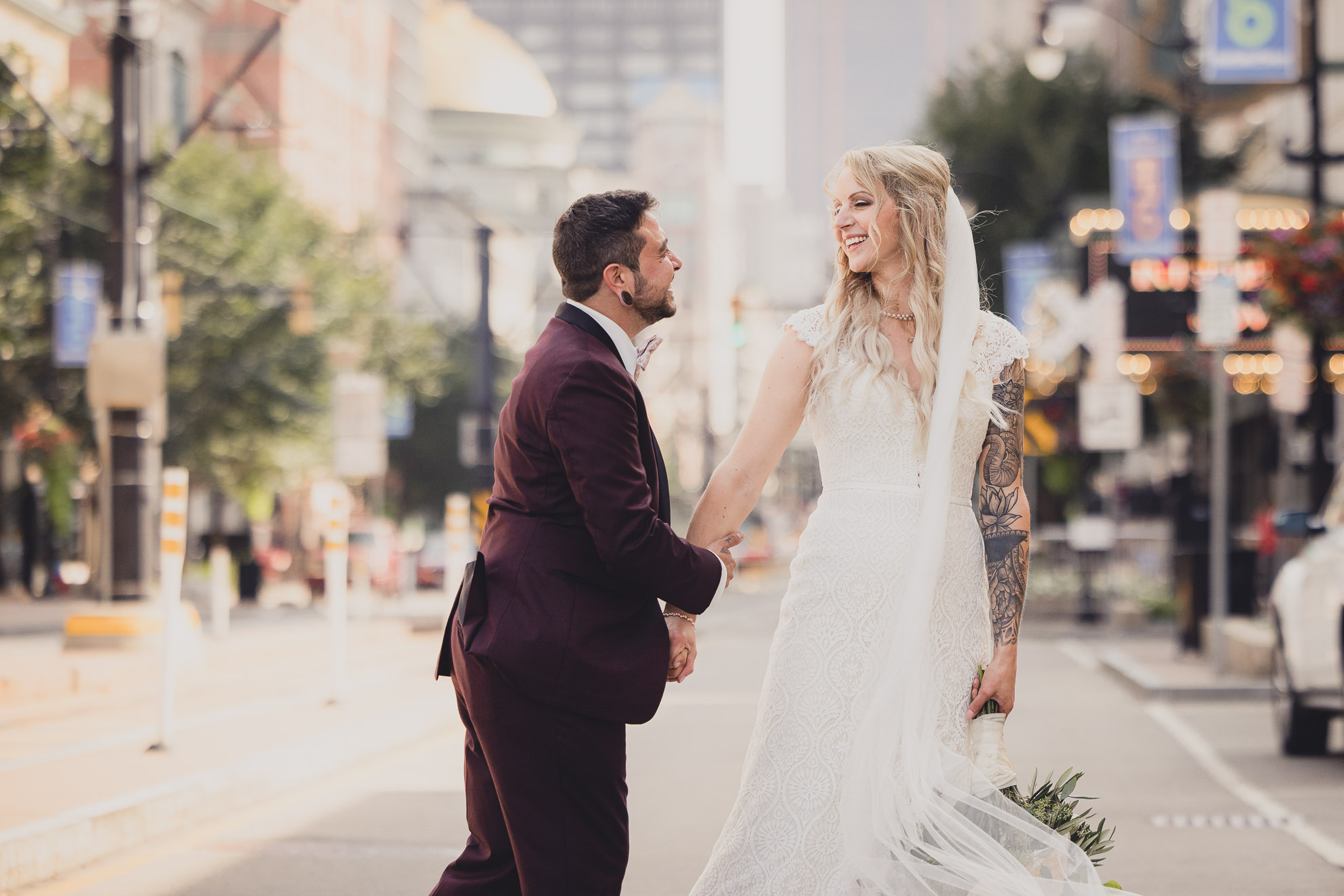 bride and groom pose for wedding portraits near Shea's theater in Buffalo, NY