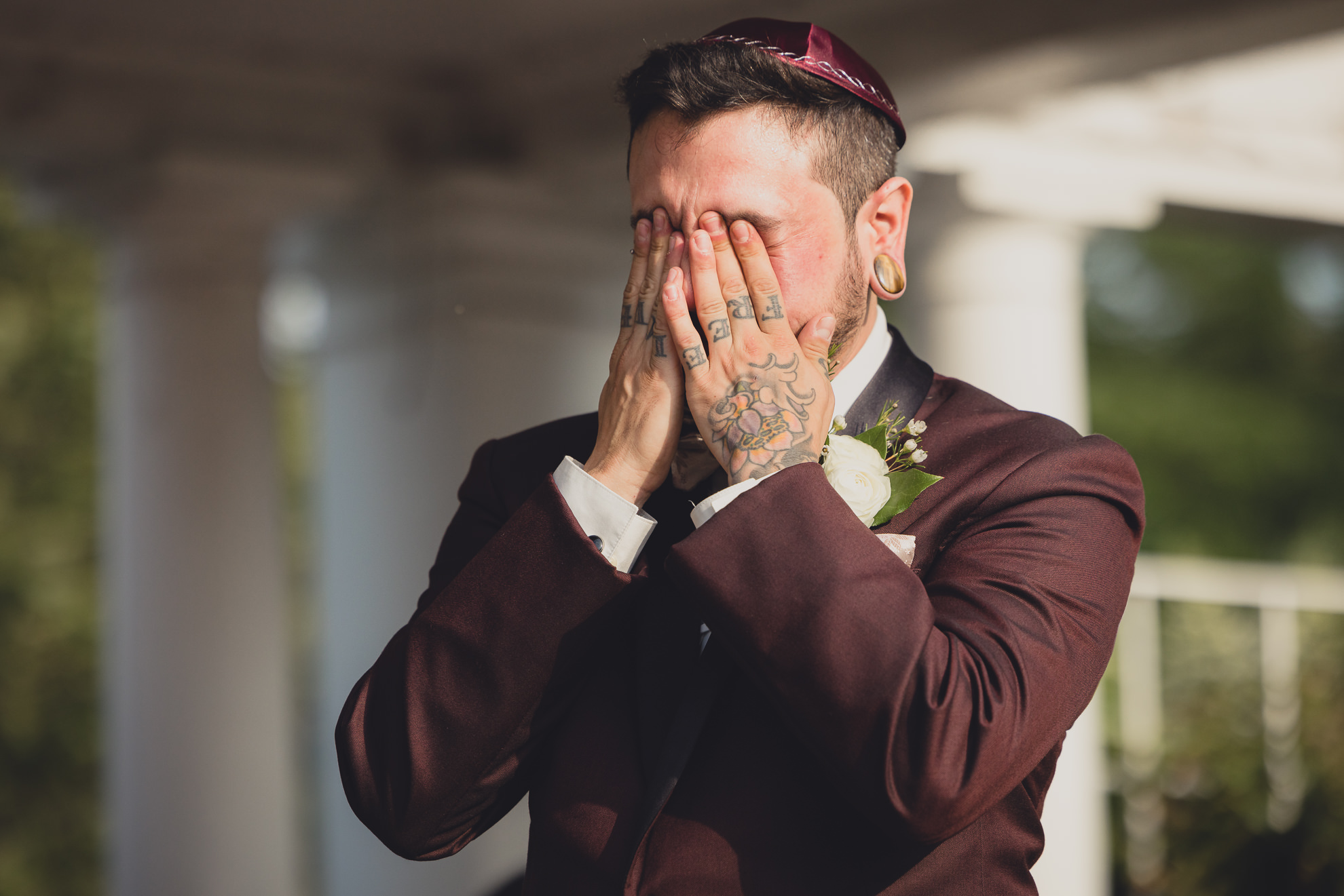 groom cries during wedding ceremony in rose garden at Marcy Casino in Buffalo, NY