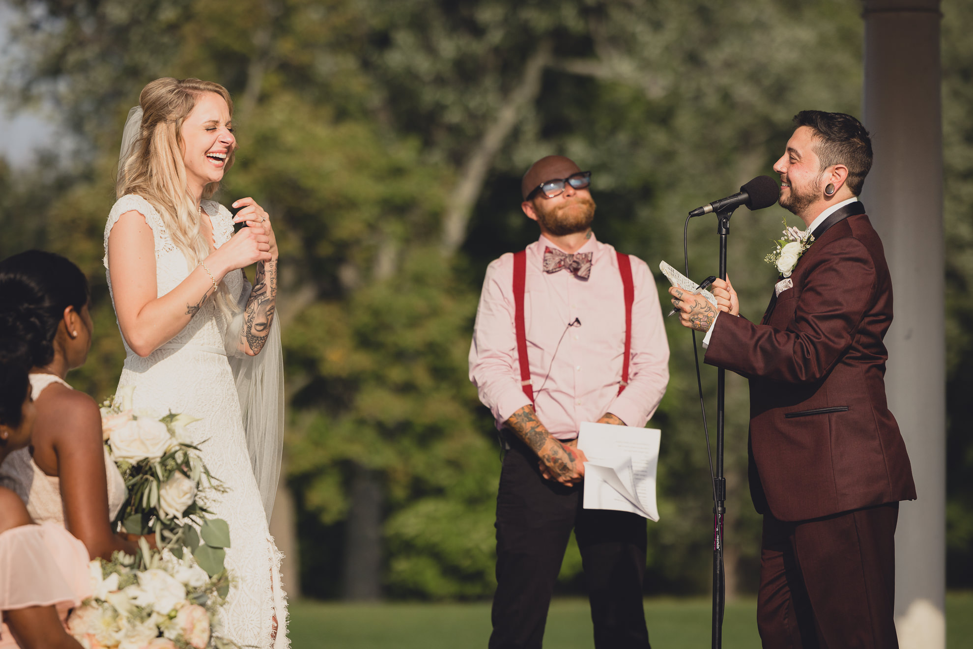 bride and groom exchange vows during wedding ceremony in rose garden at Marcy Casino in Buffalo, NY