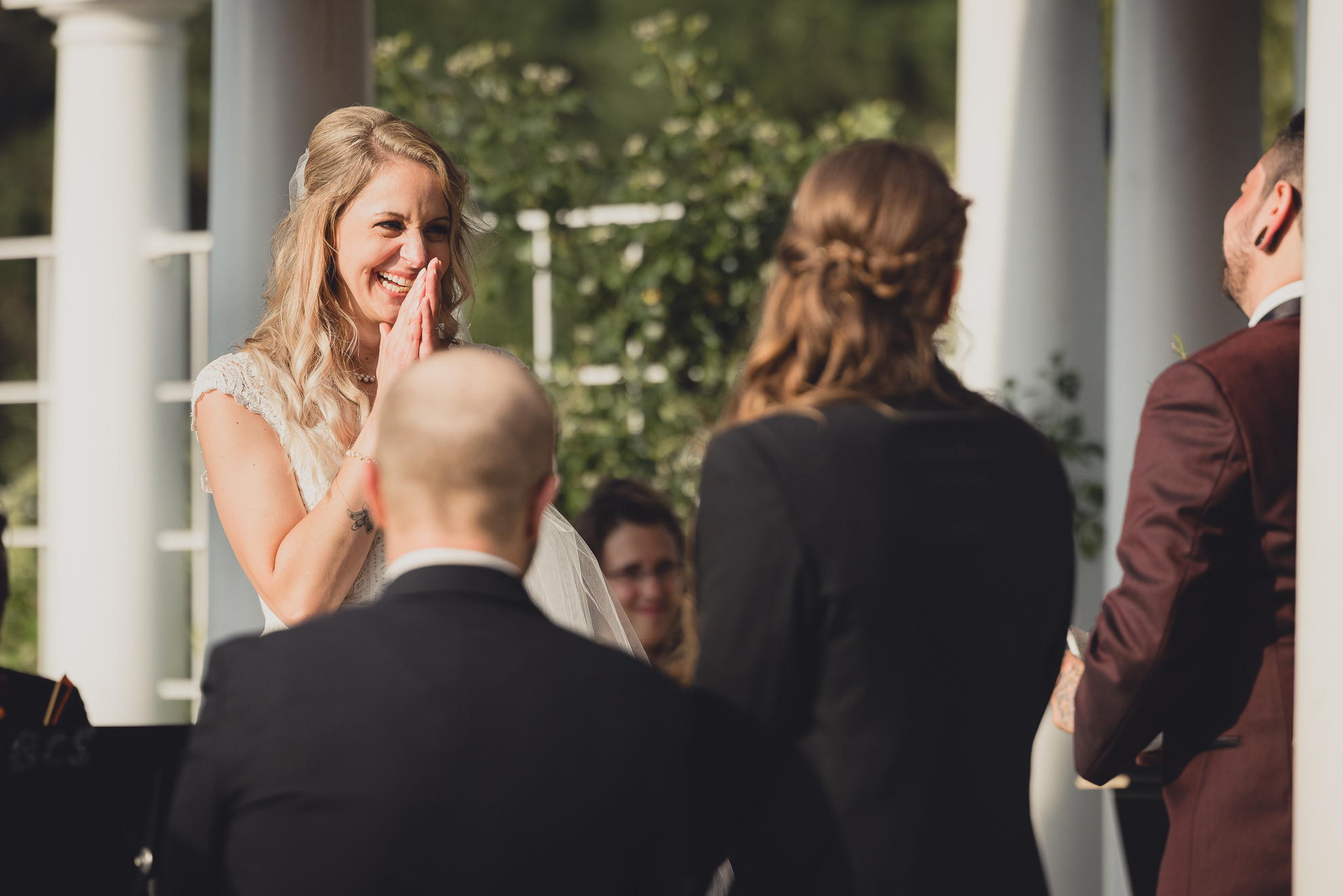 bride and groom exchange vows during wedding ceremony in rose garden at Marcy Casino in Buffalo, NY