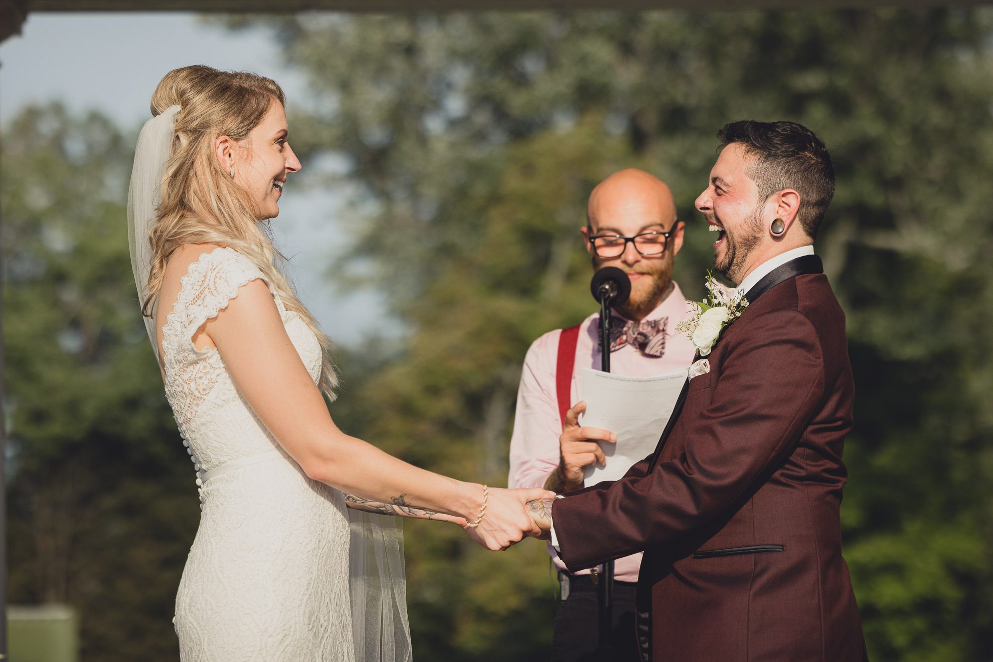 bride and groom exchange vows during wedding ceremony in rose garden at Marcy Casino in Buffalo, NY