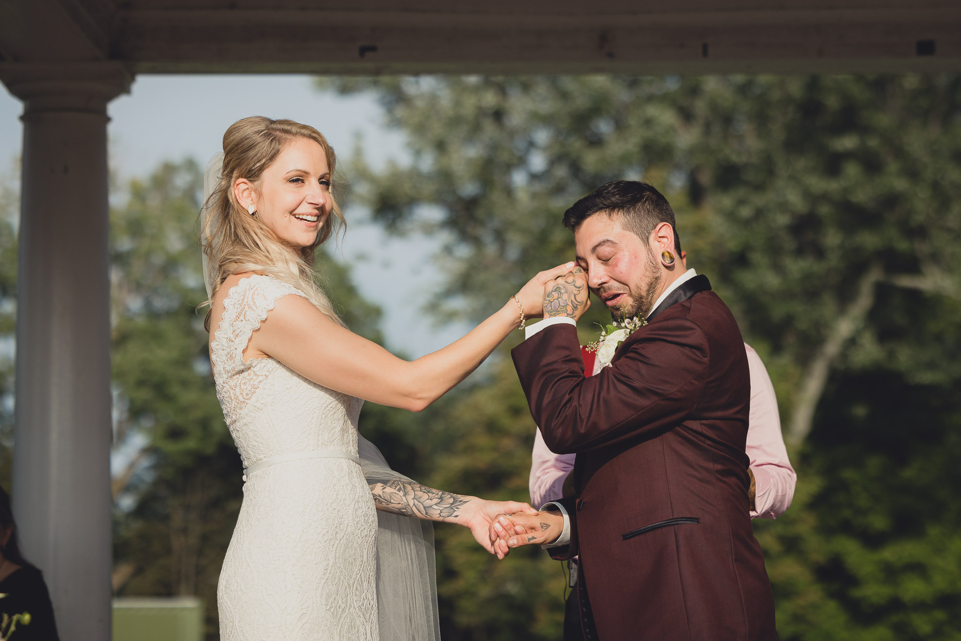 bride and groom exchange vows during wedding ceremony in rose garden at Marcy Casino in Buffalo, NY