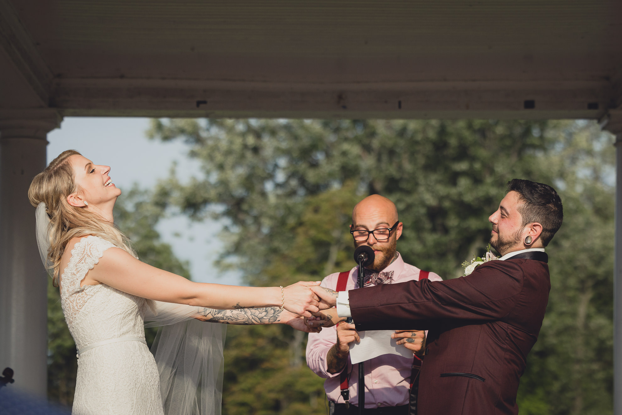 bride and groom exchange vows during wedding ceremony in rose garden at Marcy Casino in Buffalo, NY