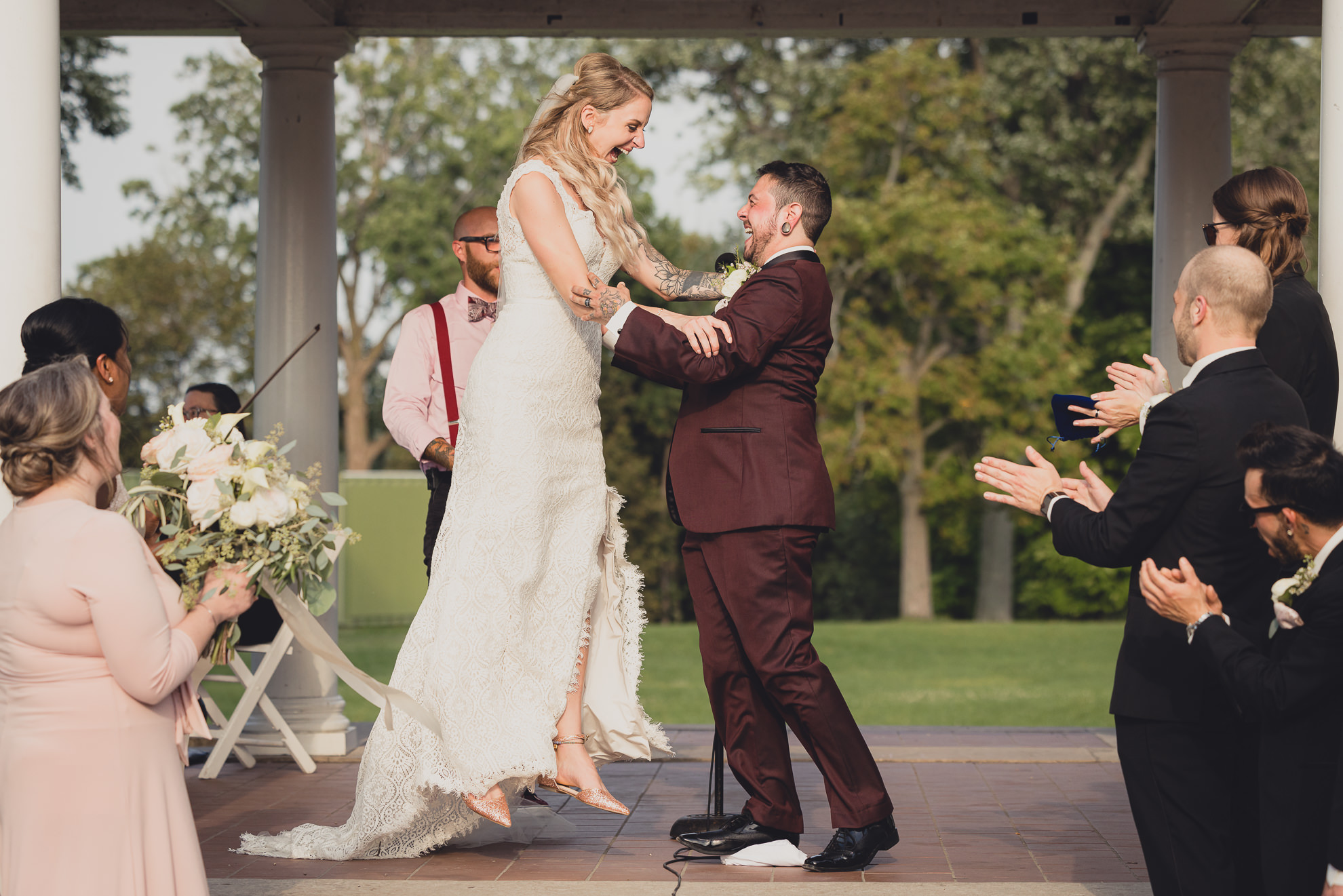 bride and groom cheer during wedding ceremony in rose garden at Marcy Casino in Buffalo,NY