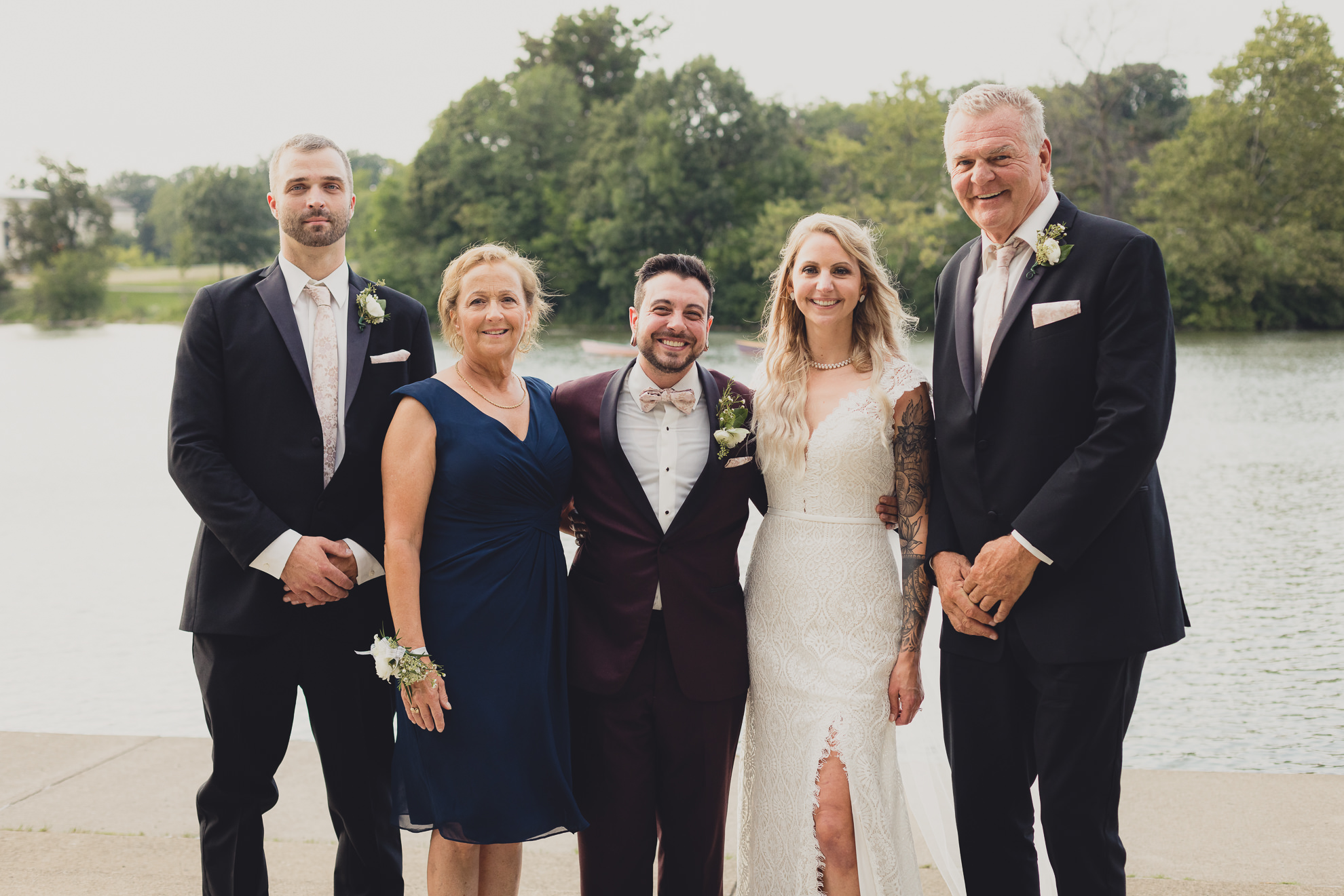 family portrait in front of Hoyt Lake in Delaware Park during wedding at Marcy Casino in Buffalo, NY