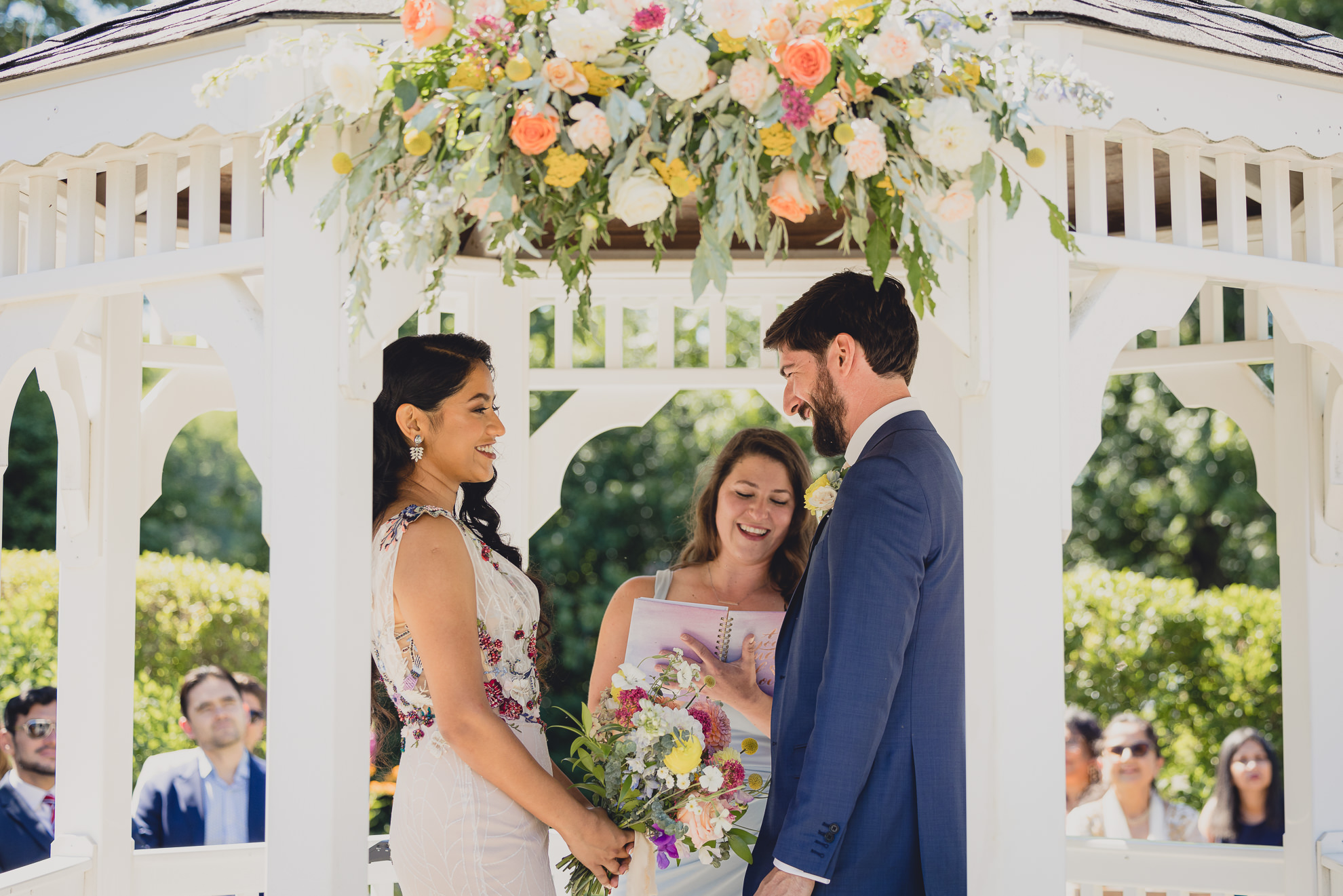 couple laughs during wedding ceremony in gazebo at mansion at Knox Farm in East Aurora, NY