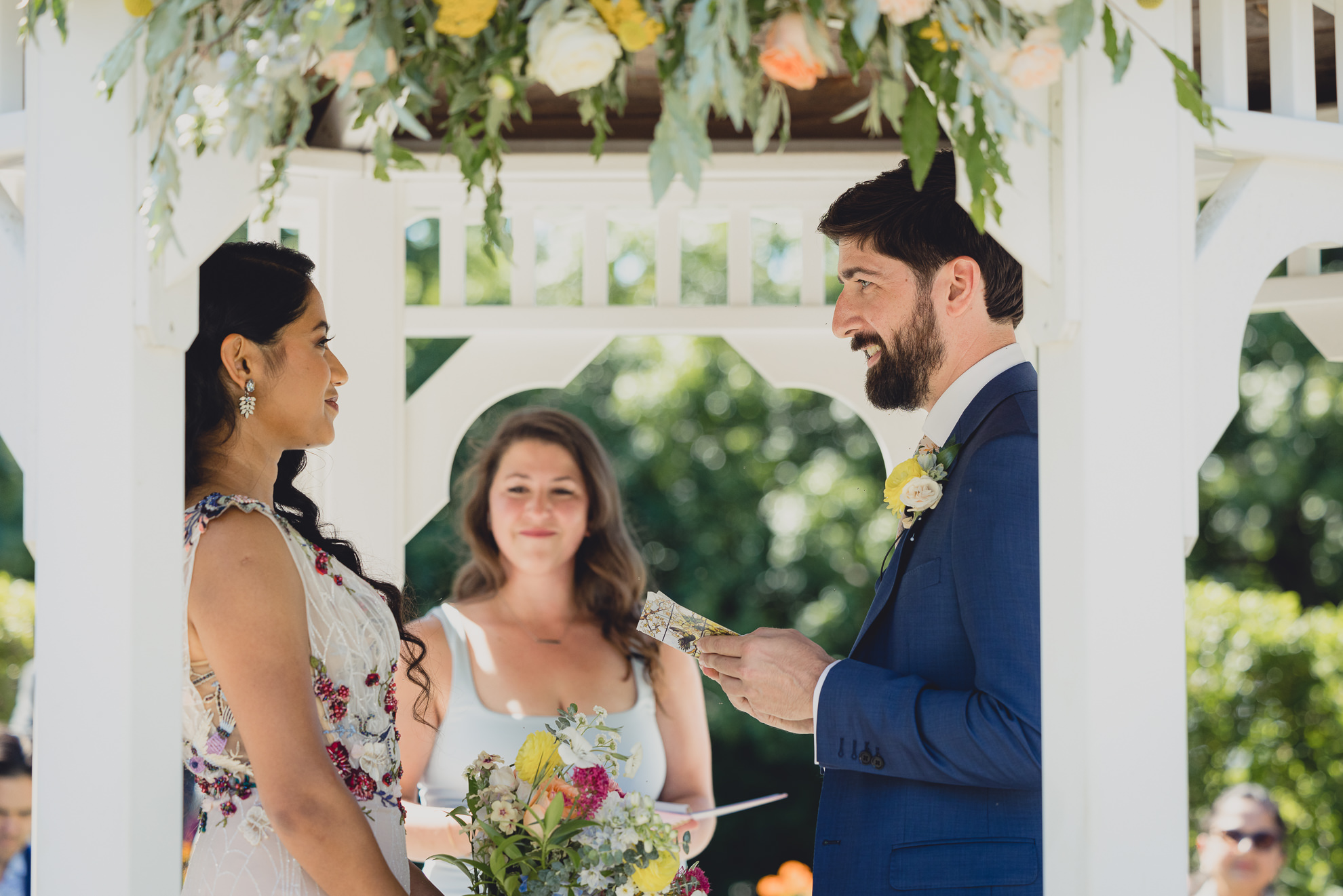 couple exchanges vows during wedding ceremony in gazebo at mansion at Knox Farm in East Aurora, NY