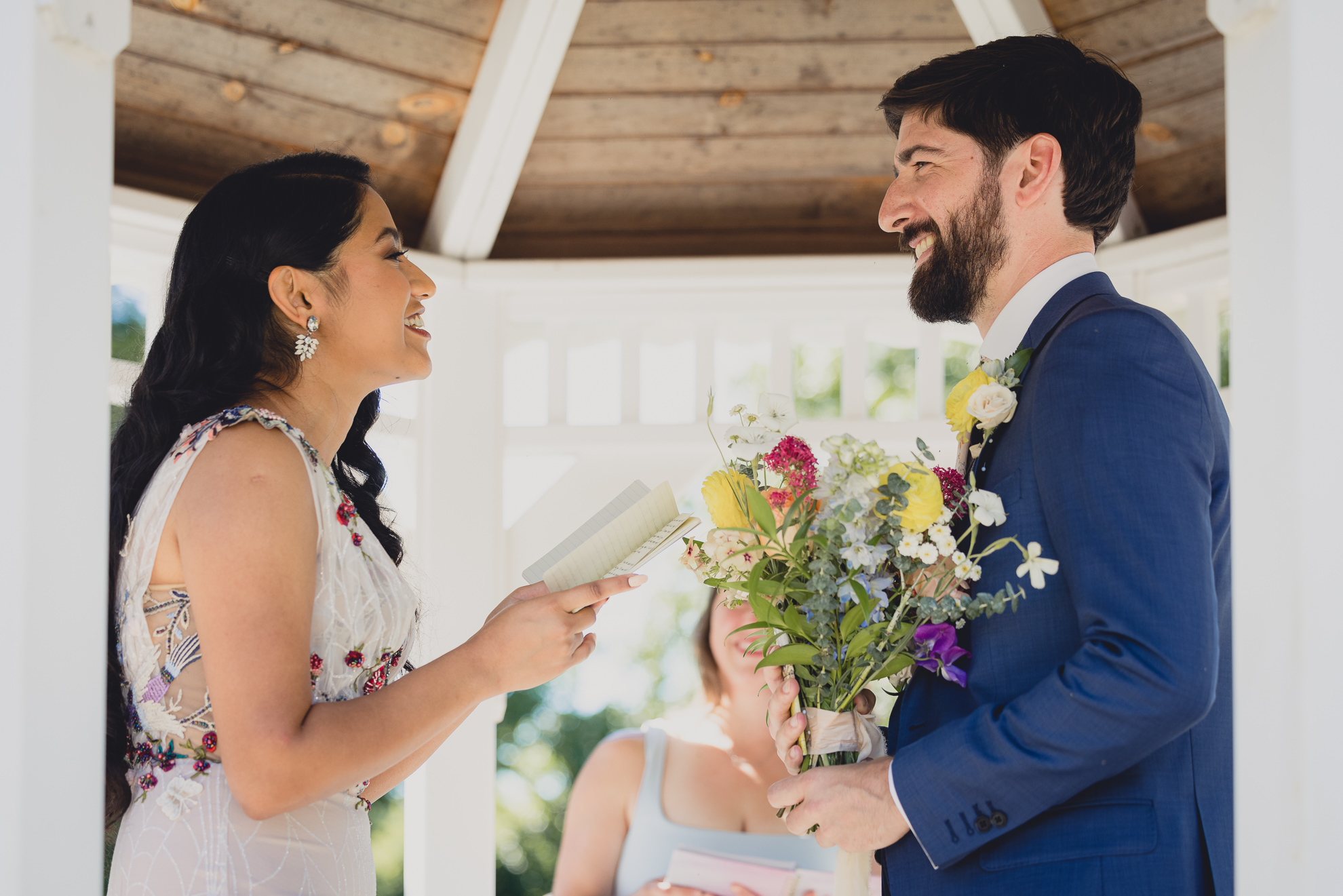 couple exchanges vows during wedding ceremony in gazebo at mansion at Knox Farm in East Aurora, NY