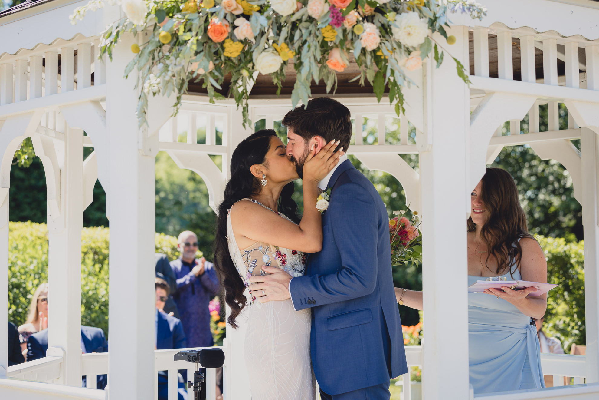couple kisses after wedding ceremony in gazebo at mansion at Knox Farm in East Aurora, NY