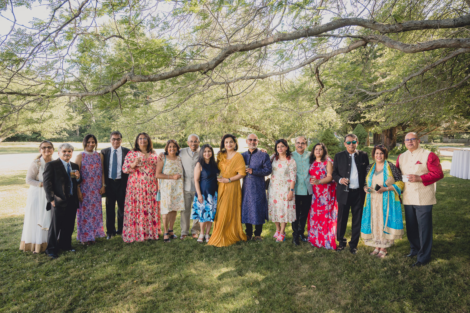 guests pose for portrait at outdoor tented wedding reception at Knox Farm in East Aurora, NY