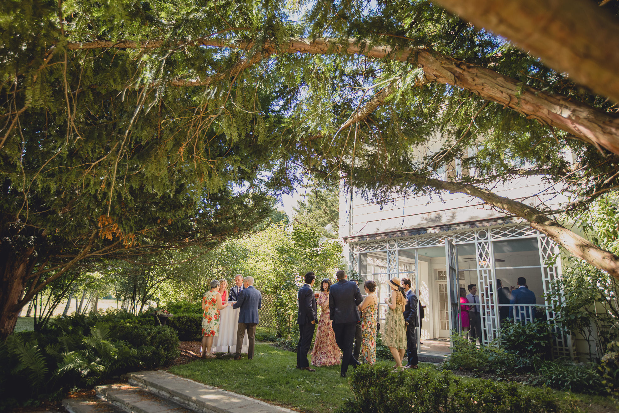 guests gather for cocktail hour at outdoor tented wedding reception at Knox Farm in East Aurora, NY