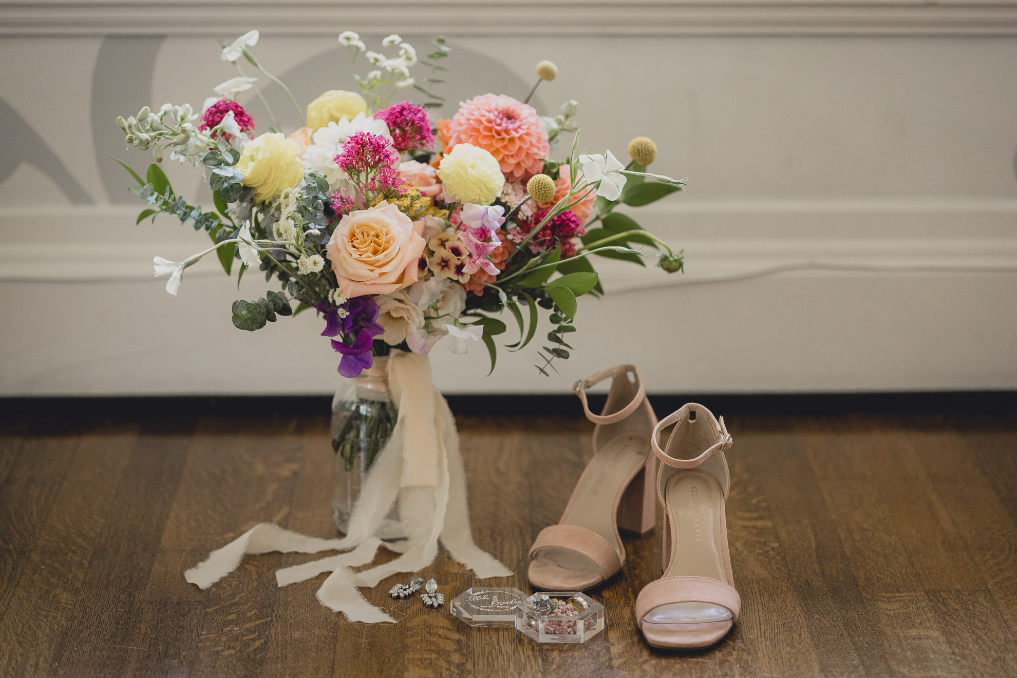brides bouquet, shoes and jewelry displayed before outdoor tented wedding at the mansion at Knox Farm in East Aurora, NY