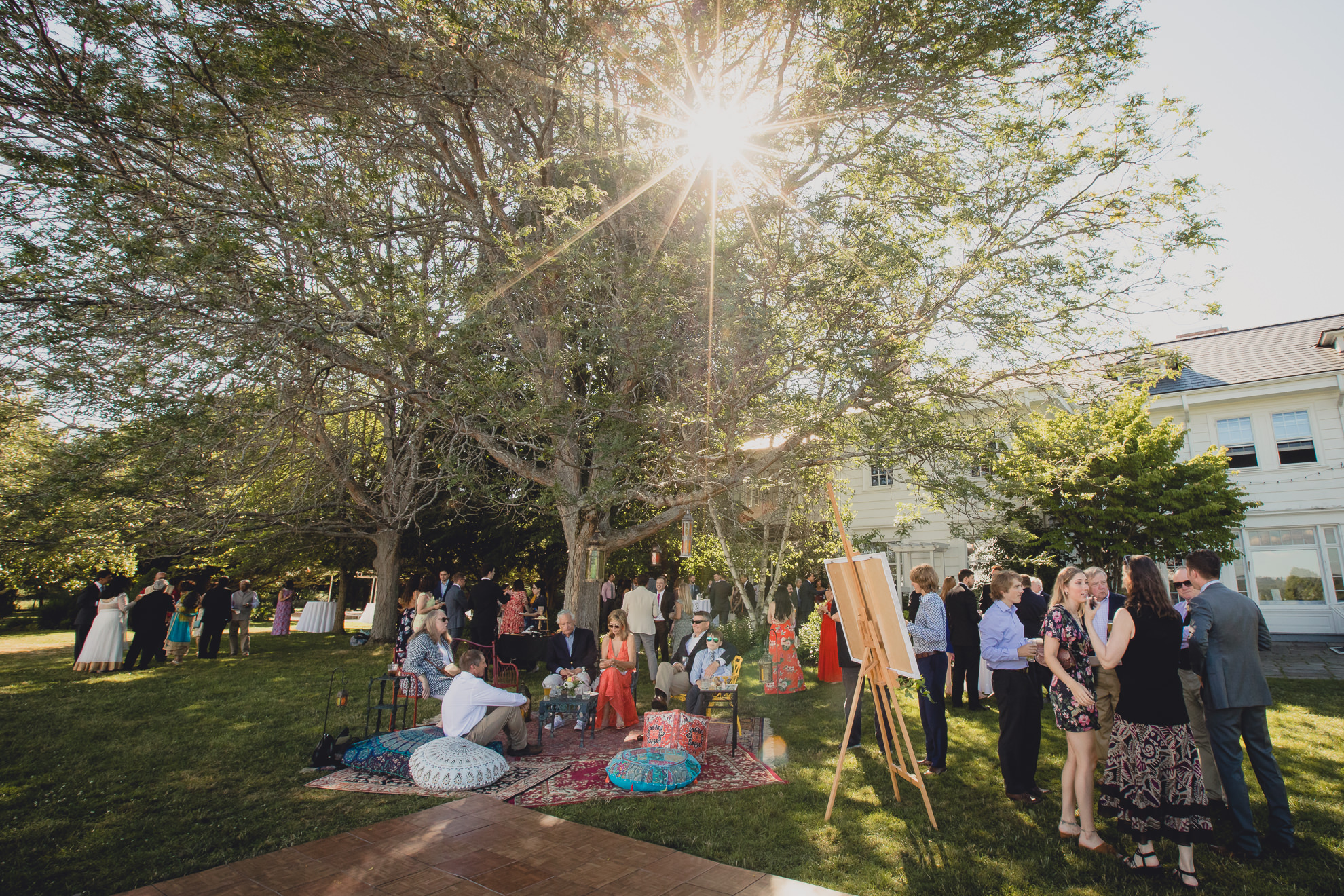 guests mingle during cocktail hour at outdoor tented wedding reception at Knox Farm in East Aurora, NY