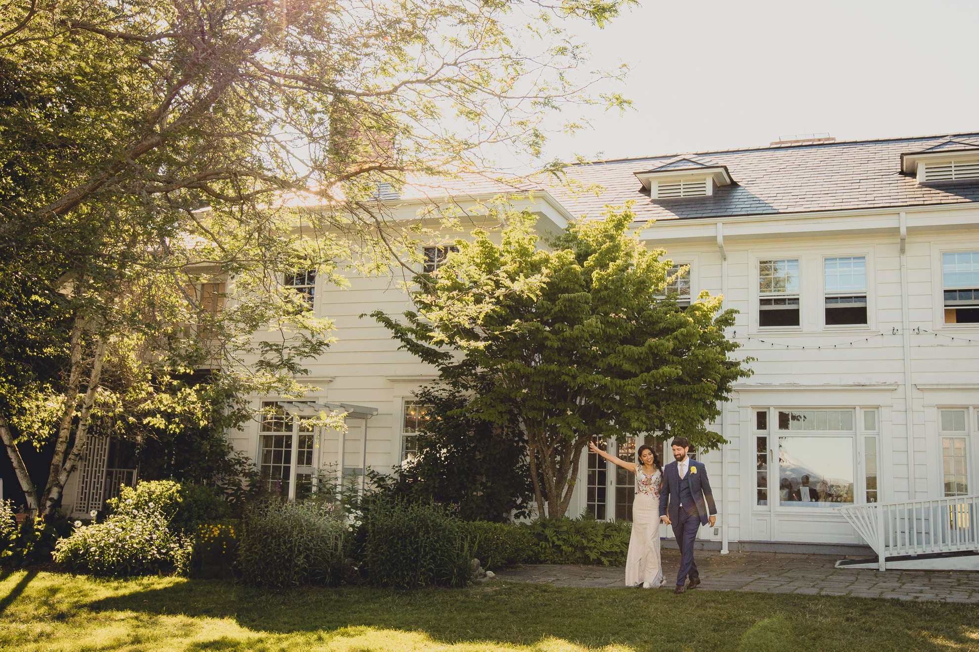 bride and groom are introduced out of mansion at outdoor tented wedding reception at Knox Farm in East Aurora, NY