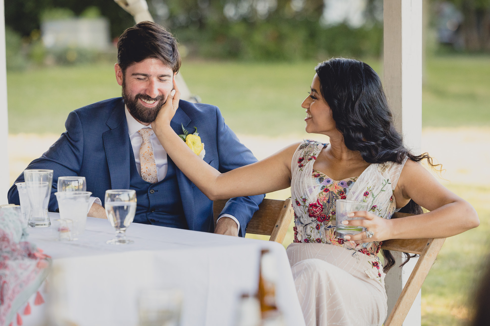bride and groom react to speech at outdoor tented wedding reception at Knox Farm in East Aurora, NY