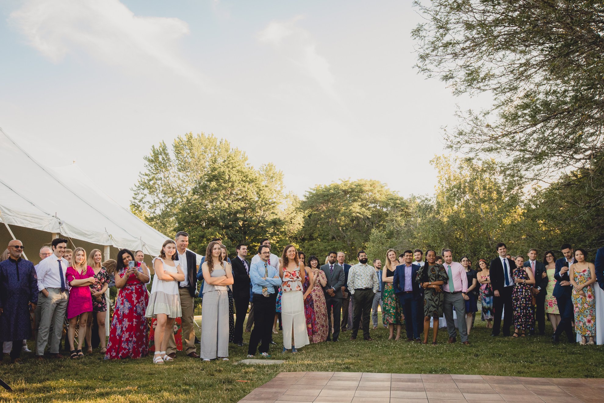 guests watch bride and groom dance at outdoor tented wedding reception at Knox Farm in East Aurora, NY