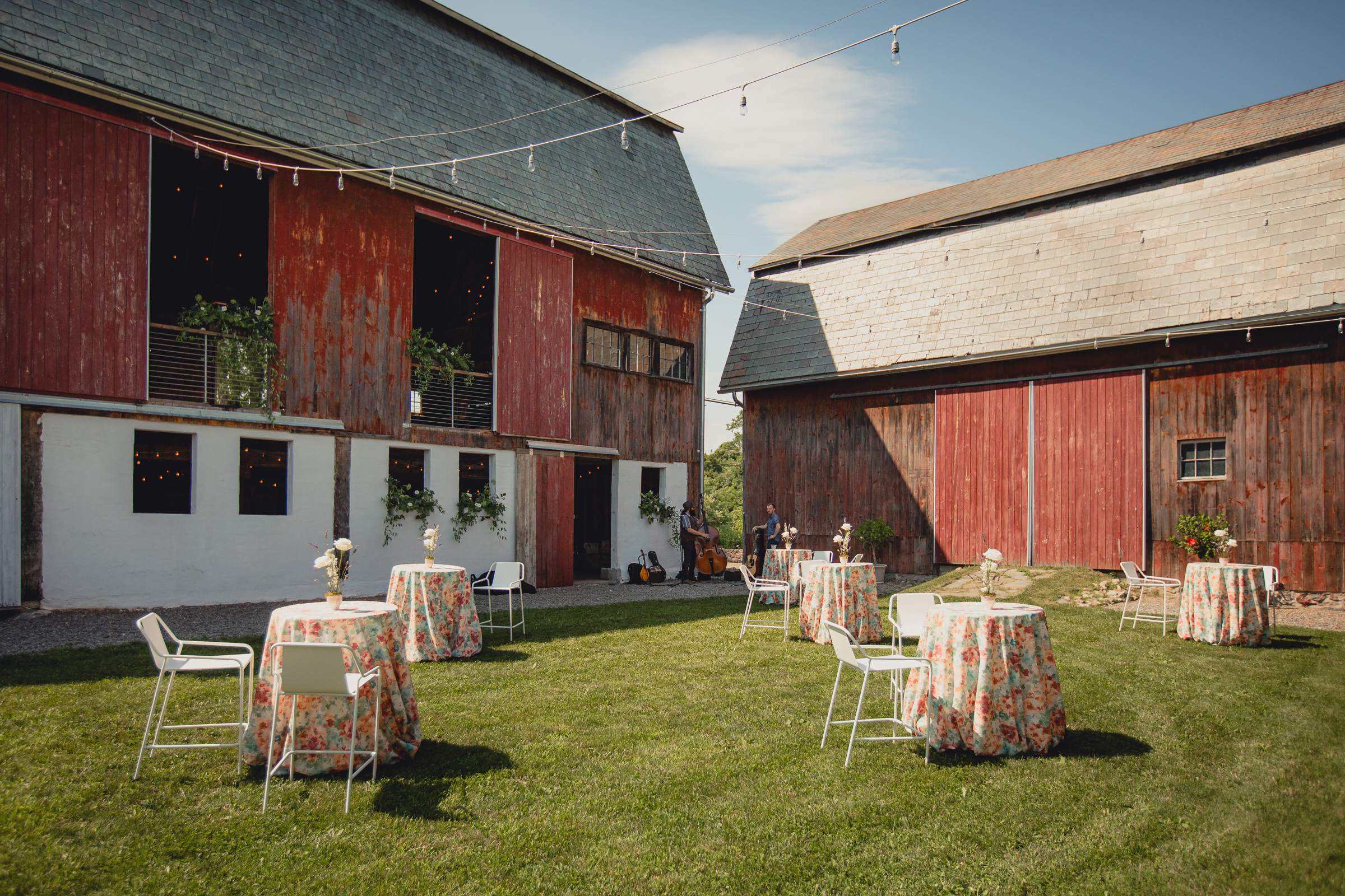 decor styled by Simply Beautiful Events and florals by Pistil and Pollen at wedding reception in barn at The North Farm in Geneva, NY
