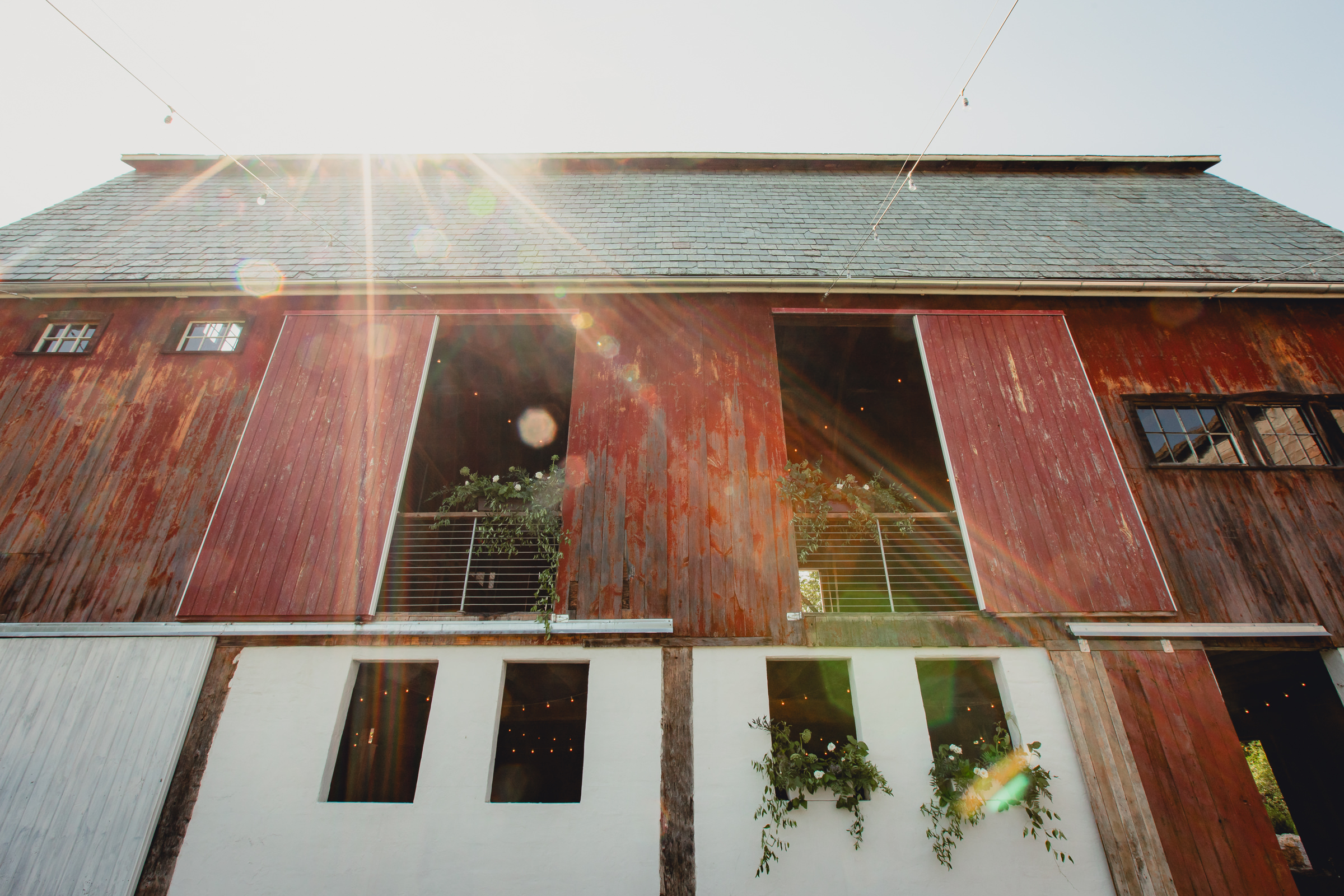 decor styled by Simply Beautiful Events and florals by Pistil and Pollen at wedding reception in barn at The North Farm in Geneva, NY