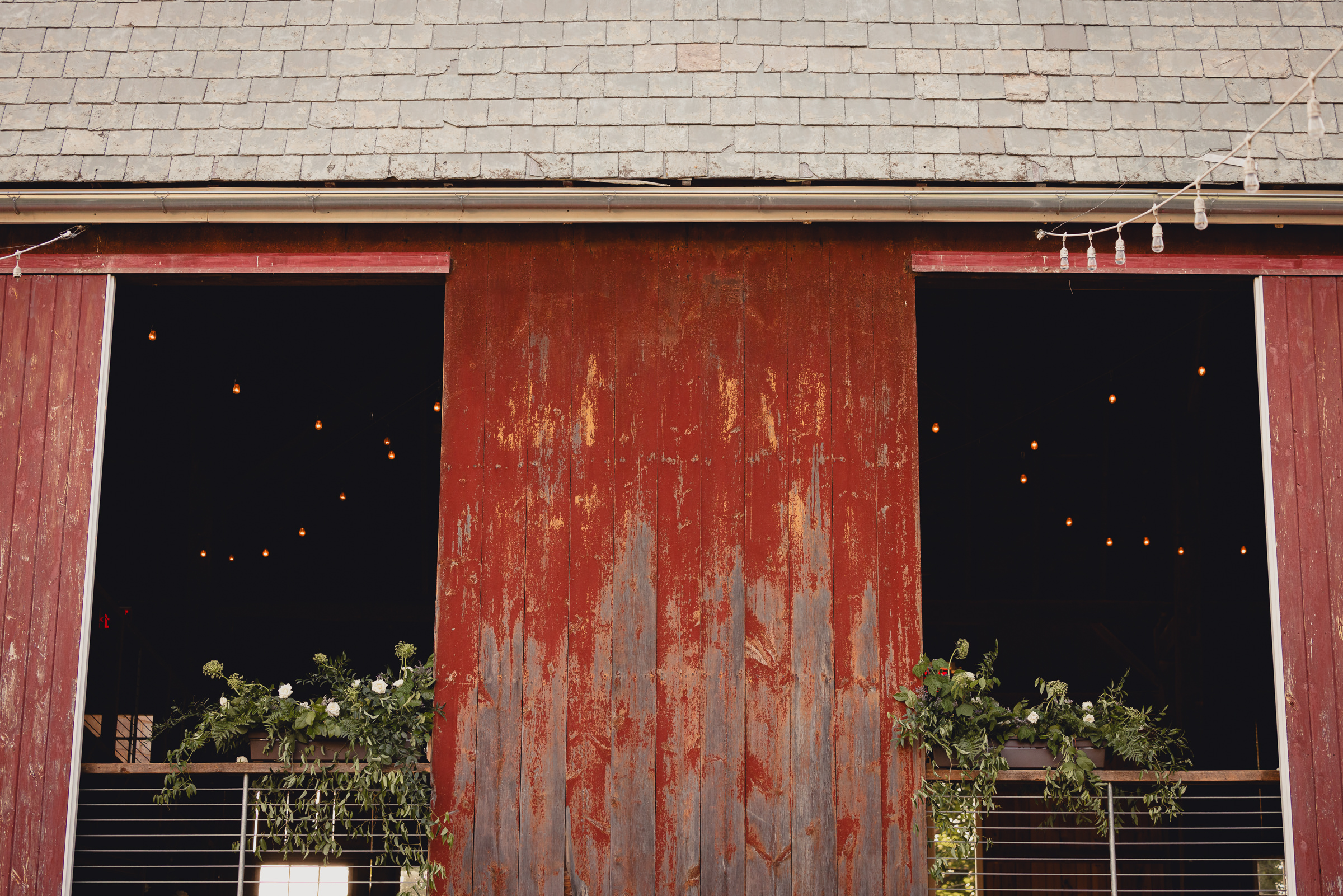 decor styled by Simply Beautiful Events and florals by Pistil and Pollen at wedding reception in barn at The North Farm in Geneva, NY
