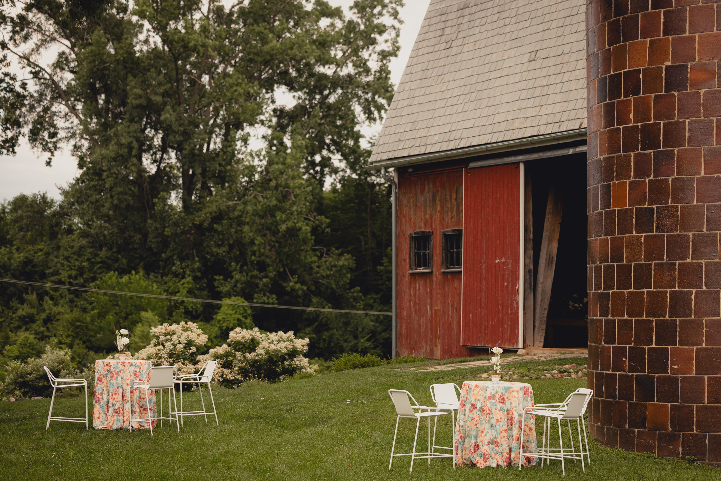 decor styled by Simply Beautiful Events and florals by Pistil and Pollen at wedding reception in barn at The North Farm in Geneva, NY